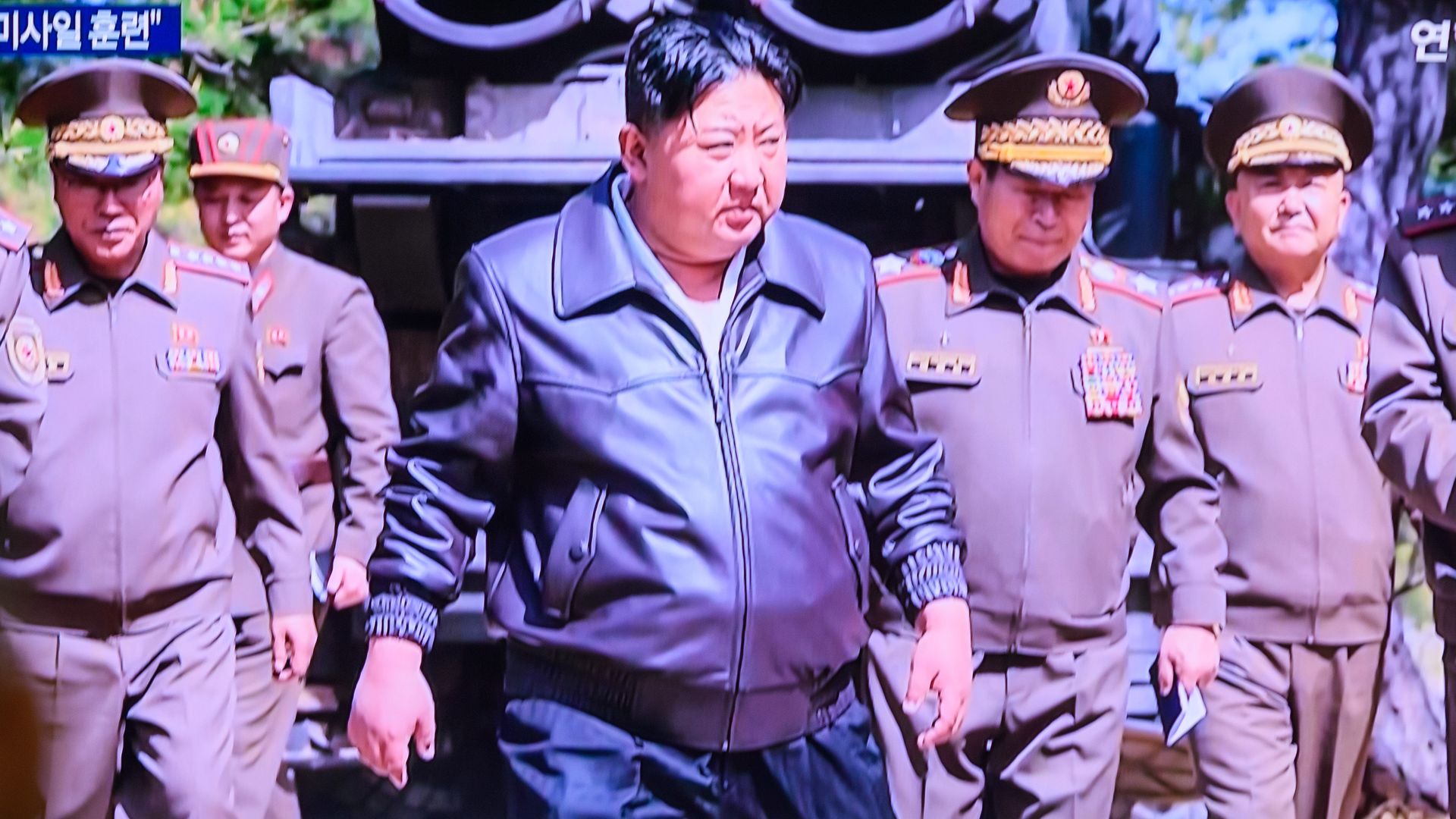  People watch a 24-hour Yonhap News TV broadcast on a large screen at Seoul Railway Station, showing North Korean leader Kim Jong Un inspecting a joint striking drill involving long-range artillery and missile systems of the Korean People's Army eastern front division, at an undisclosed location in 