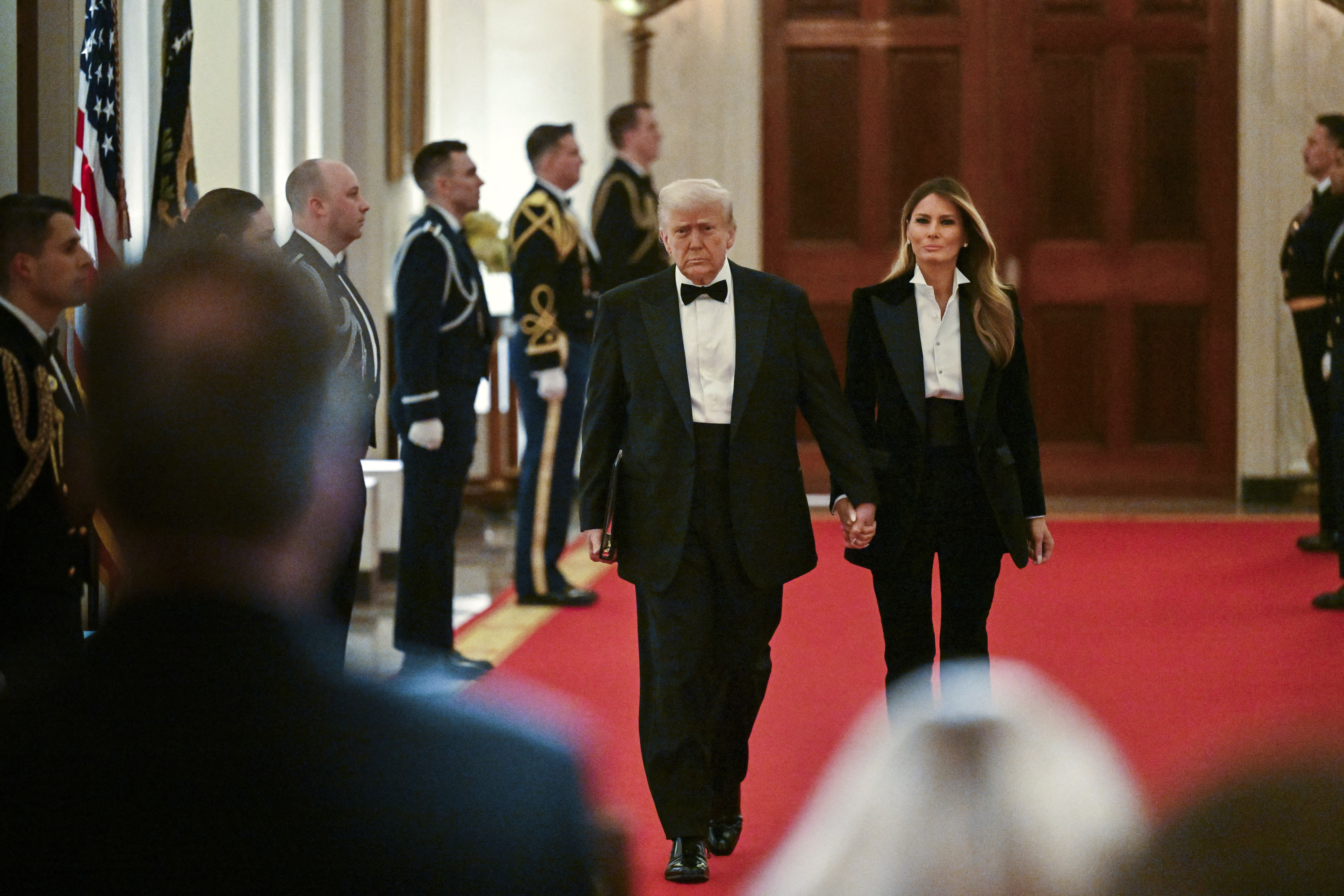 President Trump and First Lady Melania Trump arrive at the National Governors Association dinner in the East Room Saturday night.