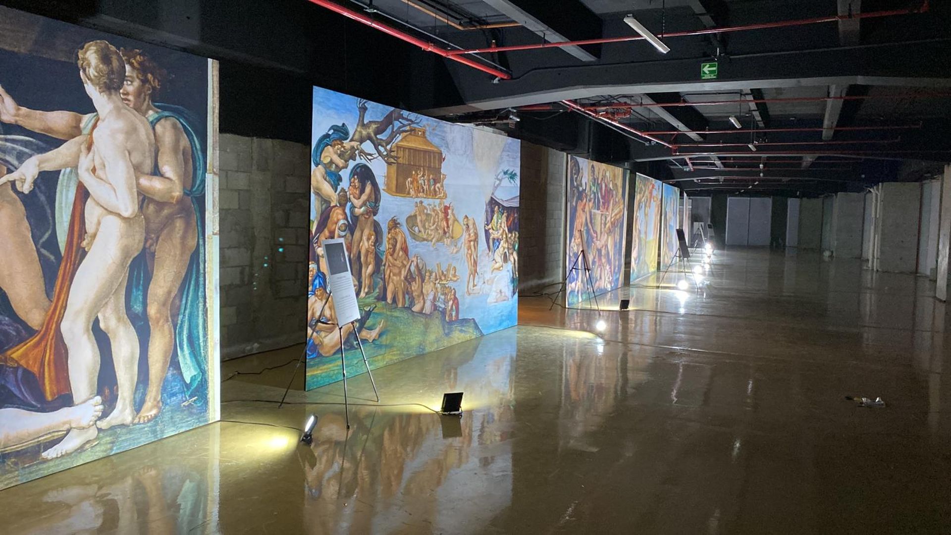 huge colorful paintings of people (naked) in a big hall 