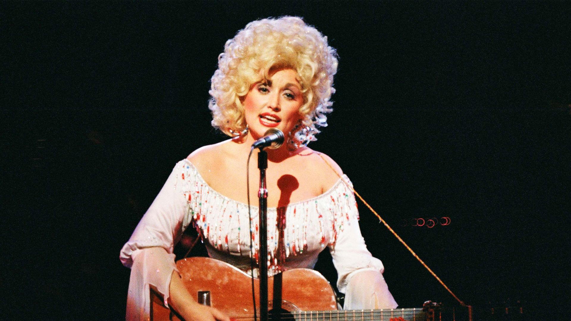 Dolly Parton performs on stage at The Dominion Theatre on March 29th, 1983 in London, United Kingdom.
