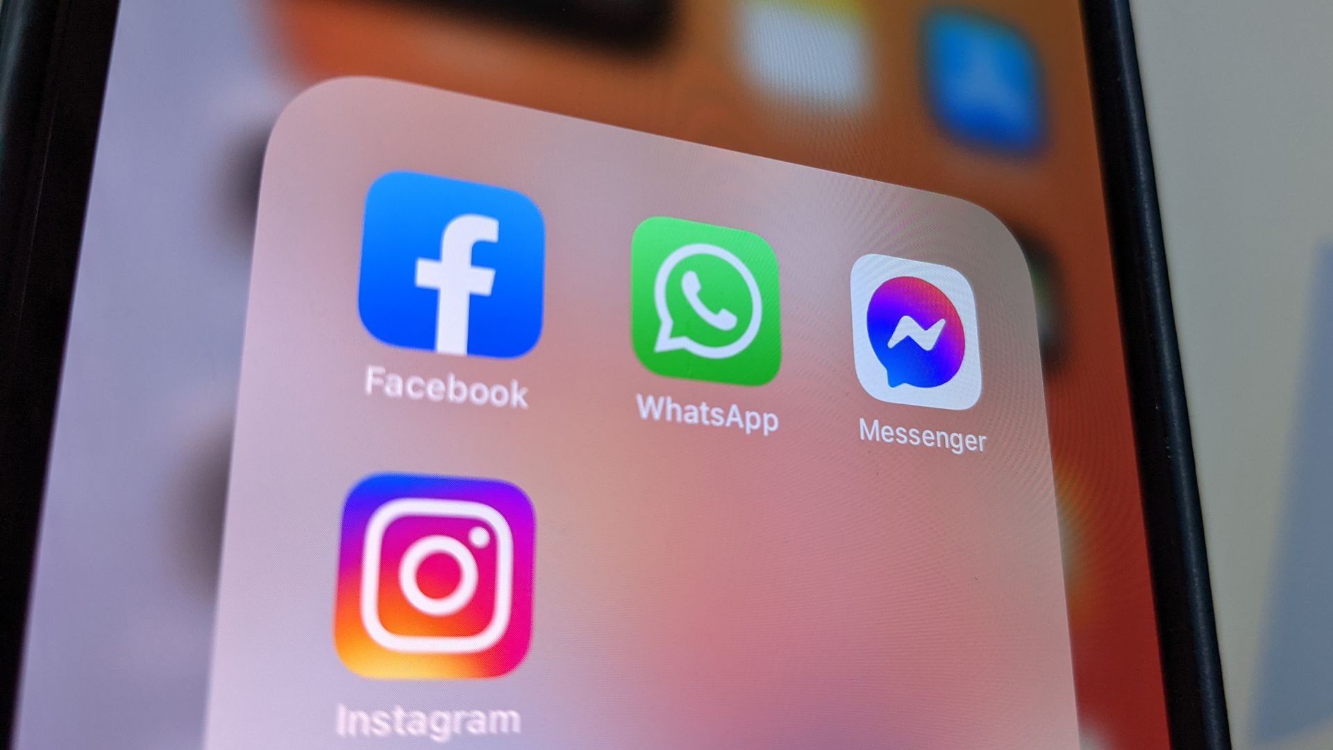 A close up of a smart phone screen with Facebook, Instagram, WhatsApp apps