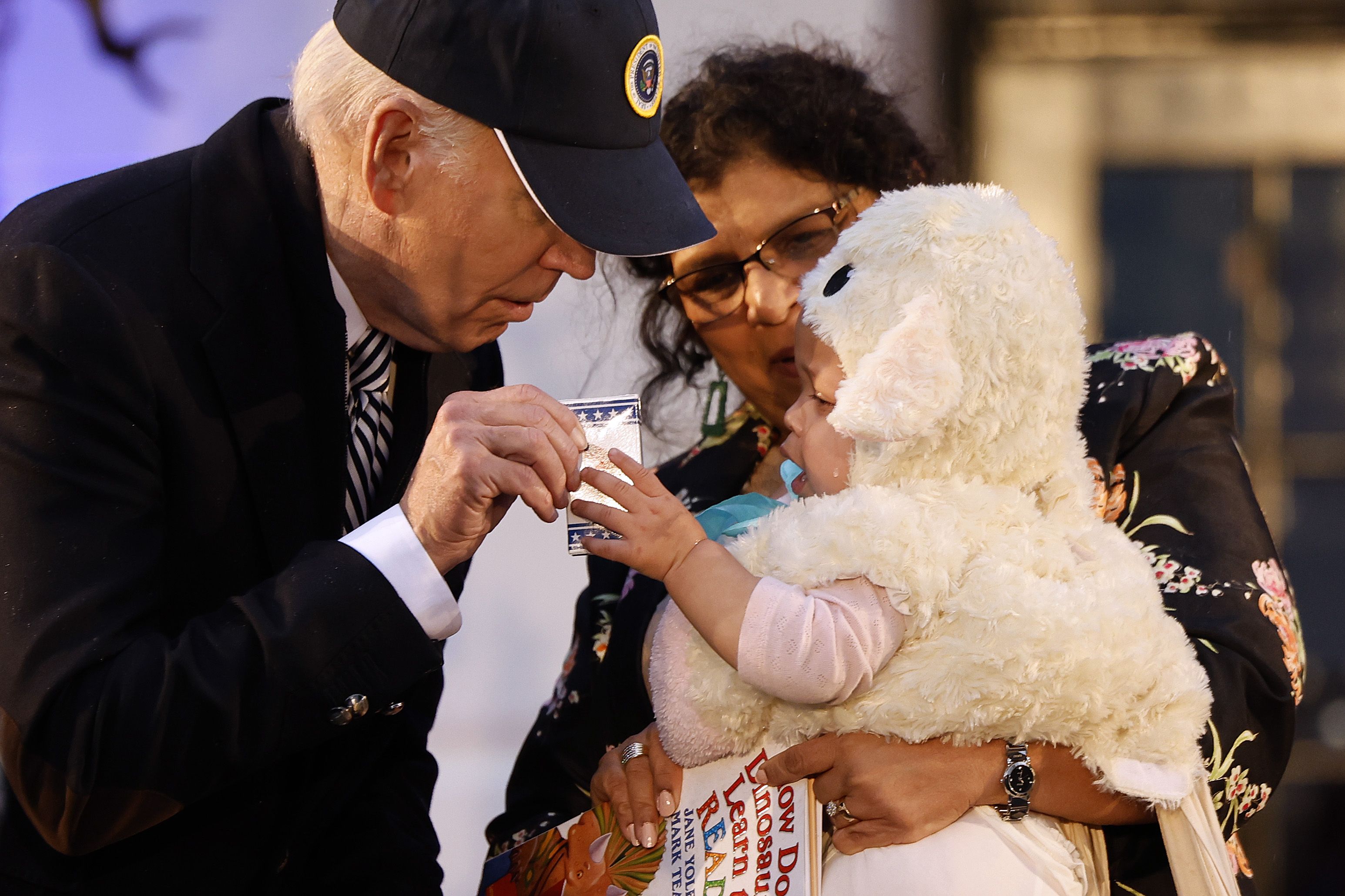 Joe Biden hands out boxes of M&Ms during a Halloween trick-or-treat event
