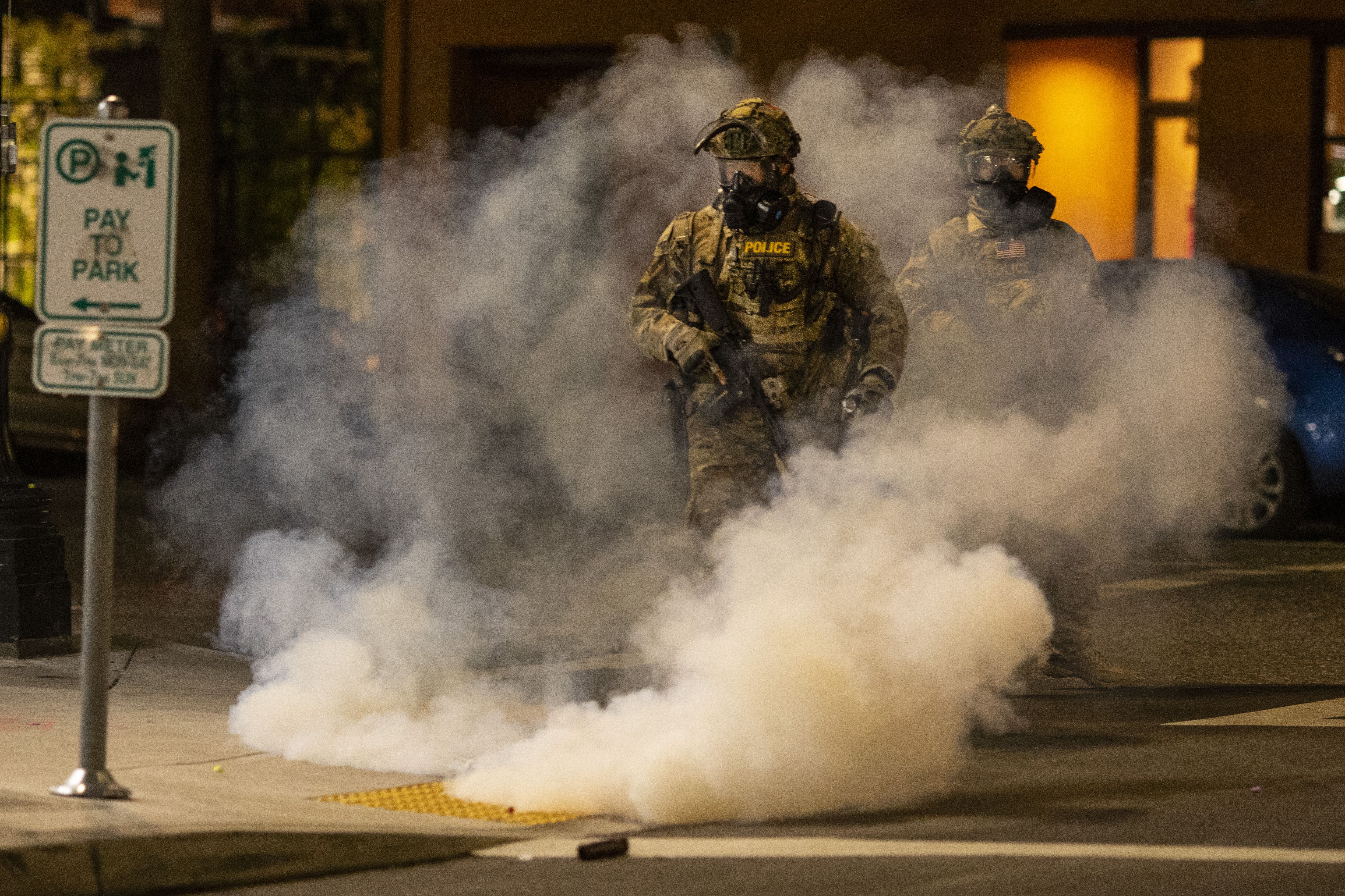 Federal officers operate amid tear gas while clearing the street in front of the Mark O. Hatfield U.S. Courthouse on in Portland, Oregon, on July 21. 