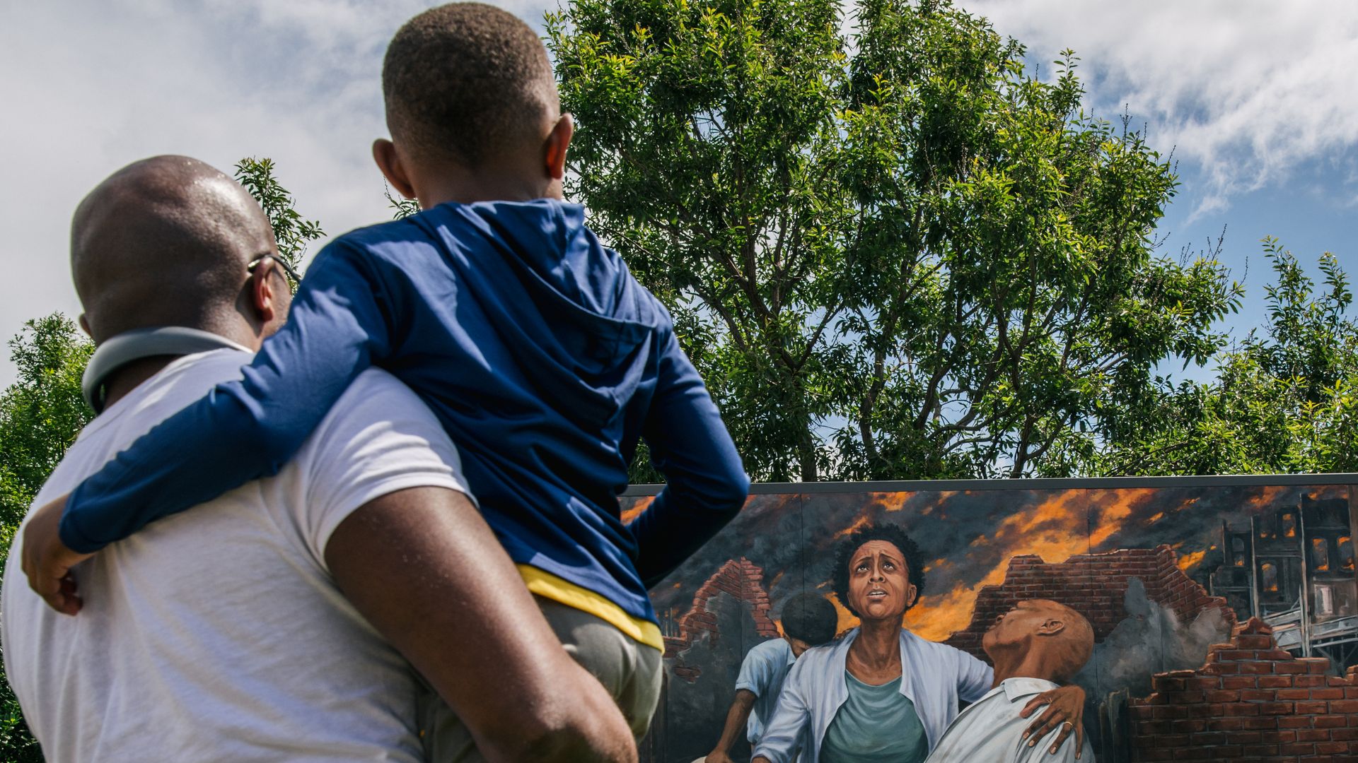 People looking at a memorial in the Greenwood district in Tulsa, Oklahoma, on May 28.