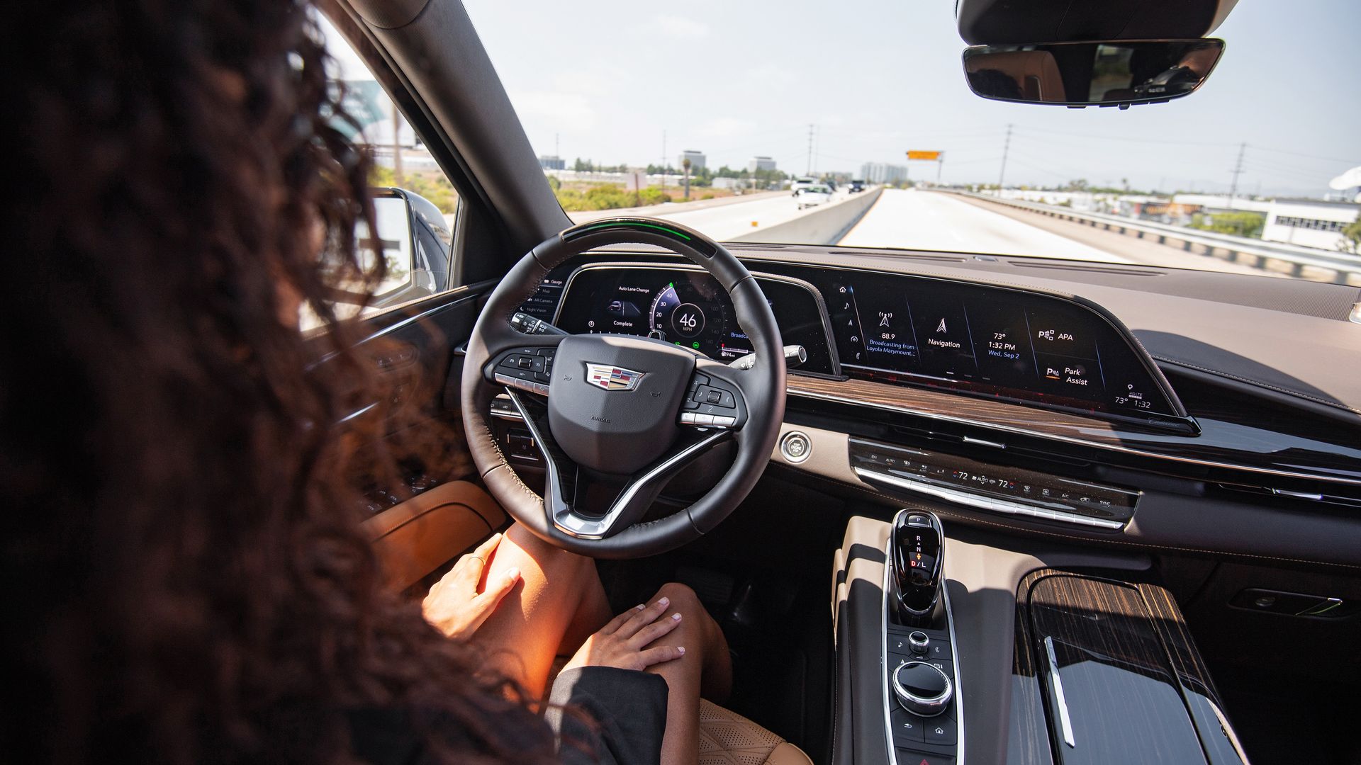 Image of a woman driving a Cadillac Escalade with Super Cruise hands-off technology