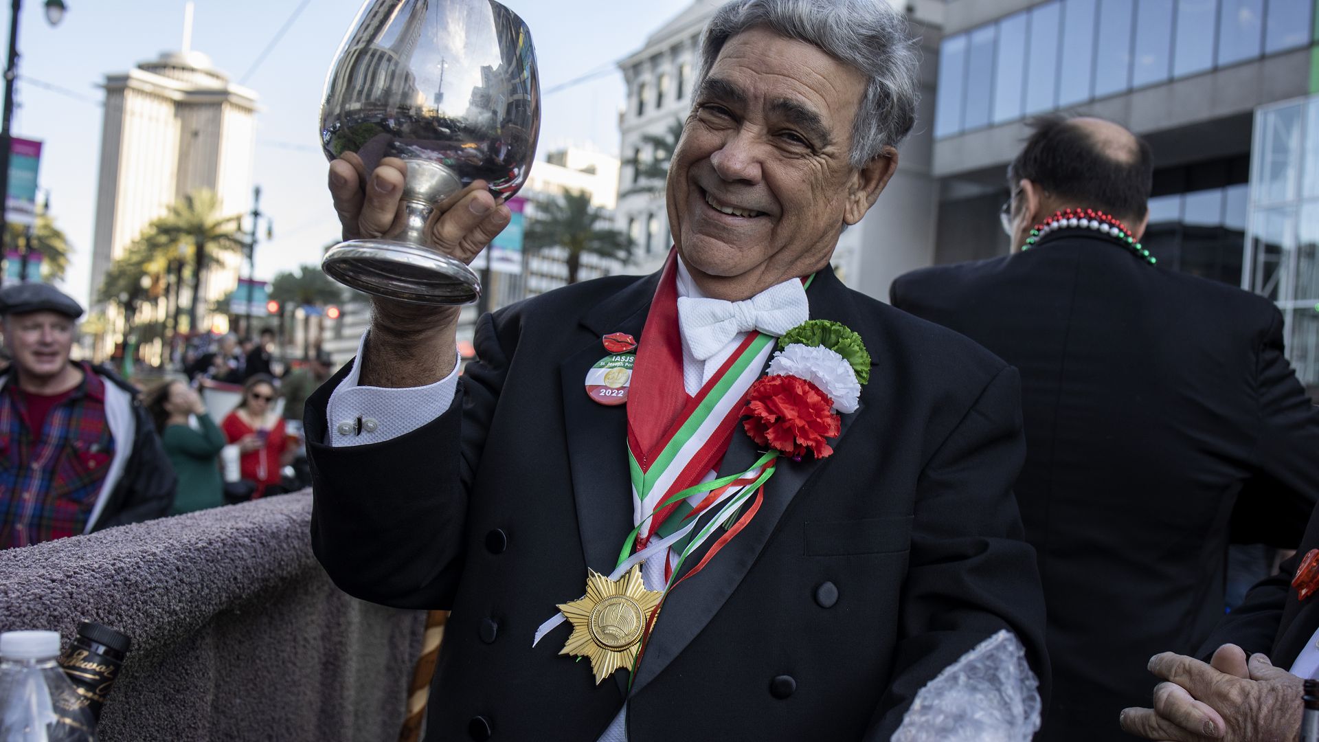 Photo shows a man holding up a silver goblet.
