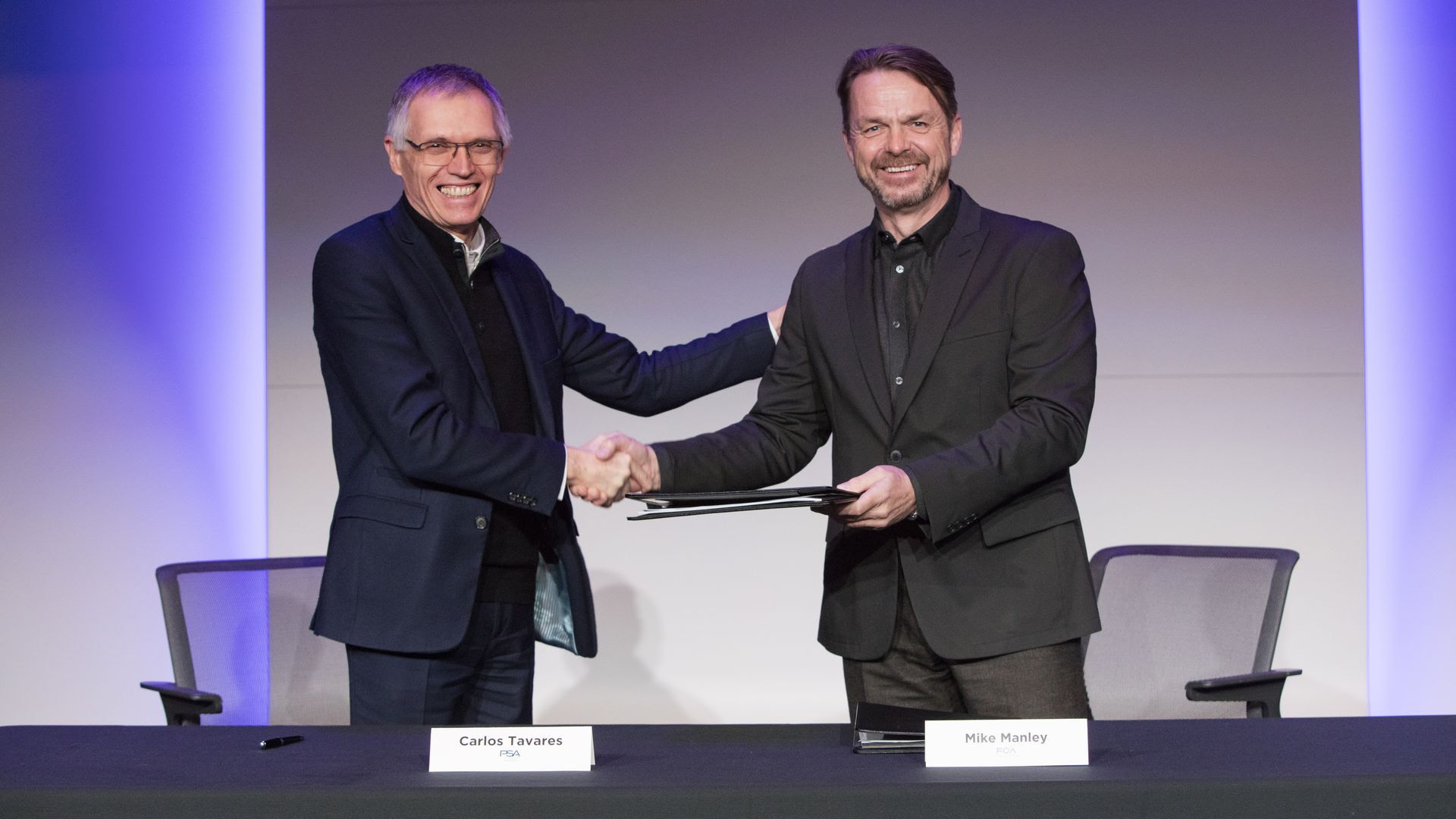 The CEO's of both companies shaking hands.