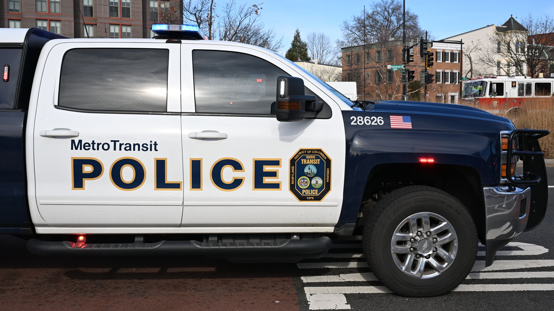 A blue and white Metro Transit Police vehicle outside a station
