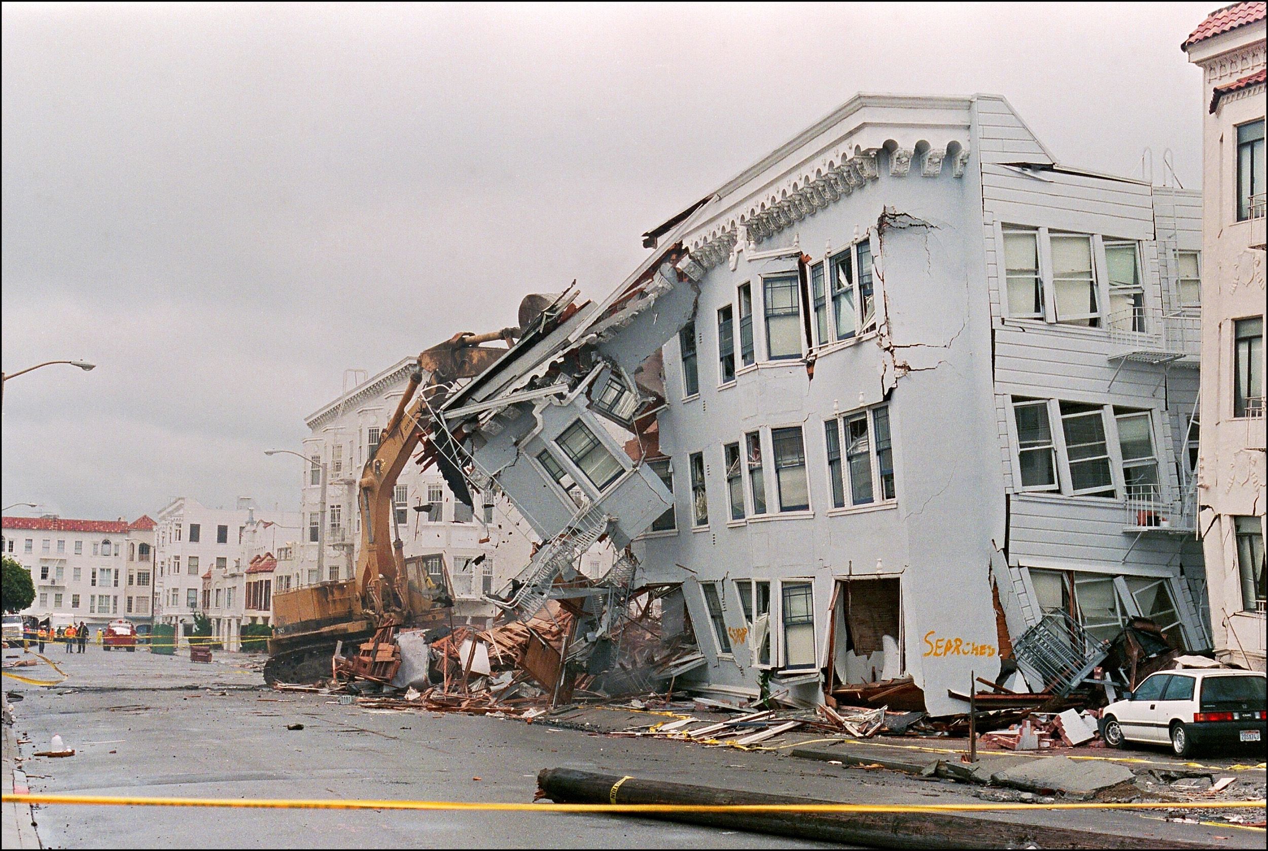 Photo of an apartment building ripped off its structure by a road