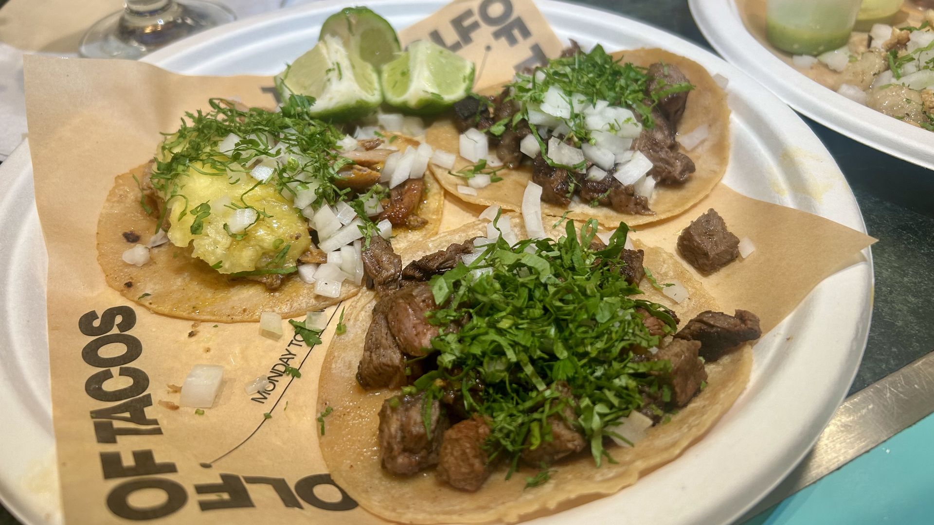 A plate with three different tacos. 