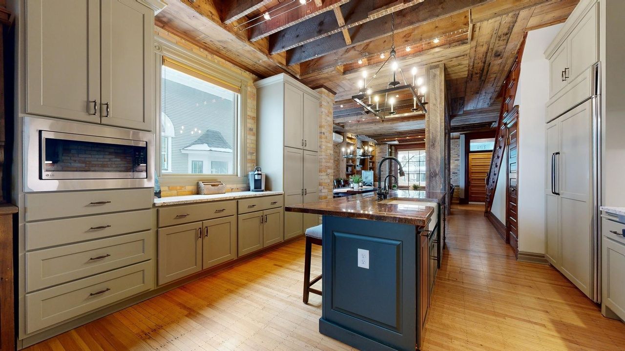 view of kitchen with stainless appliances and large wood island