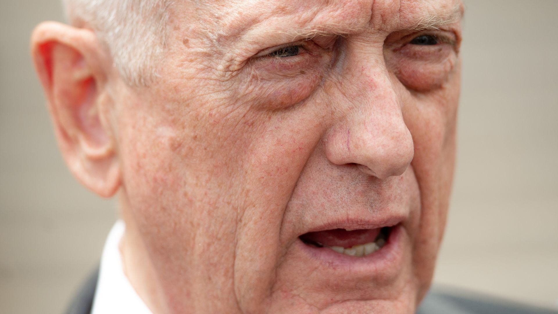 Closeup of Sec Def's Mattis face, he looks surprised.