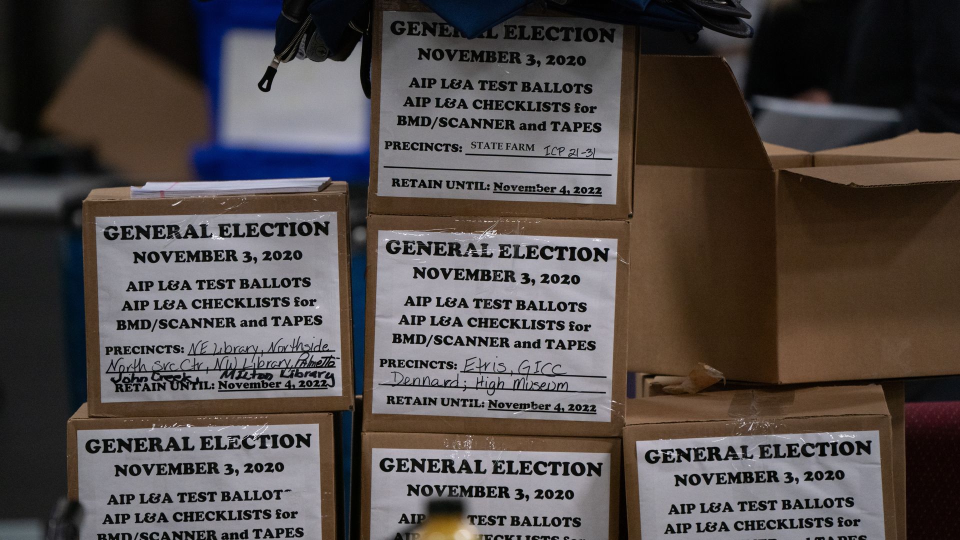 Six boxes taped with white paper that reads "General Election November 3, 2020" stacked on top of each other. 