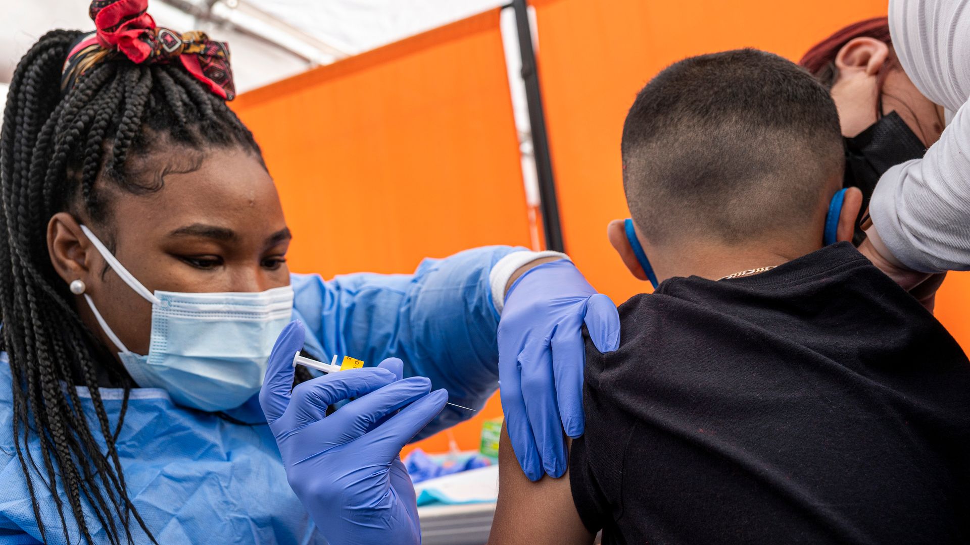 A health care worker administering a Pfizer coronavirus vaccine to a child at a facility in San Francisco in January 2022.