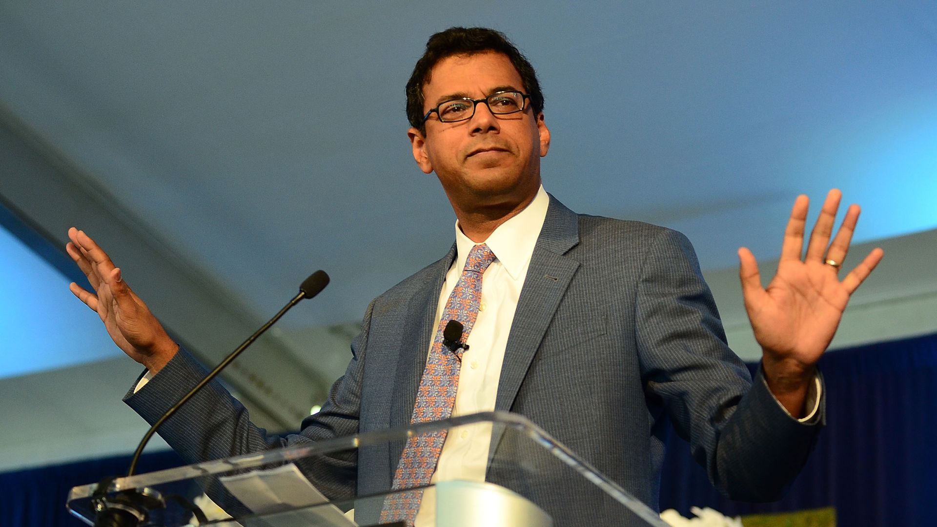 Atul Gawande speaks at a podium.