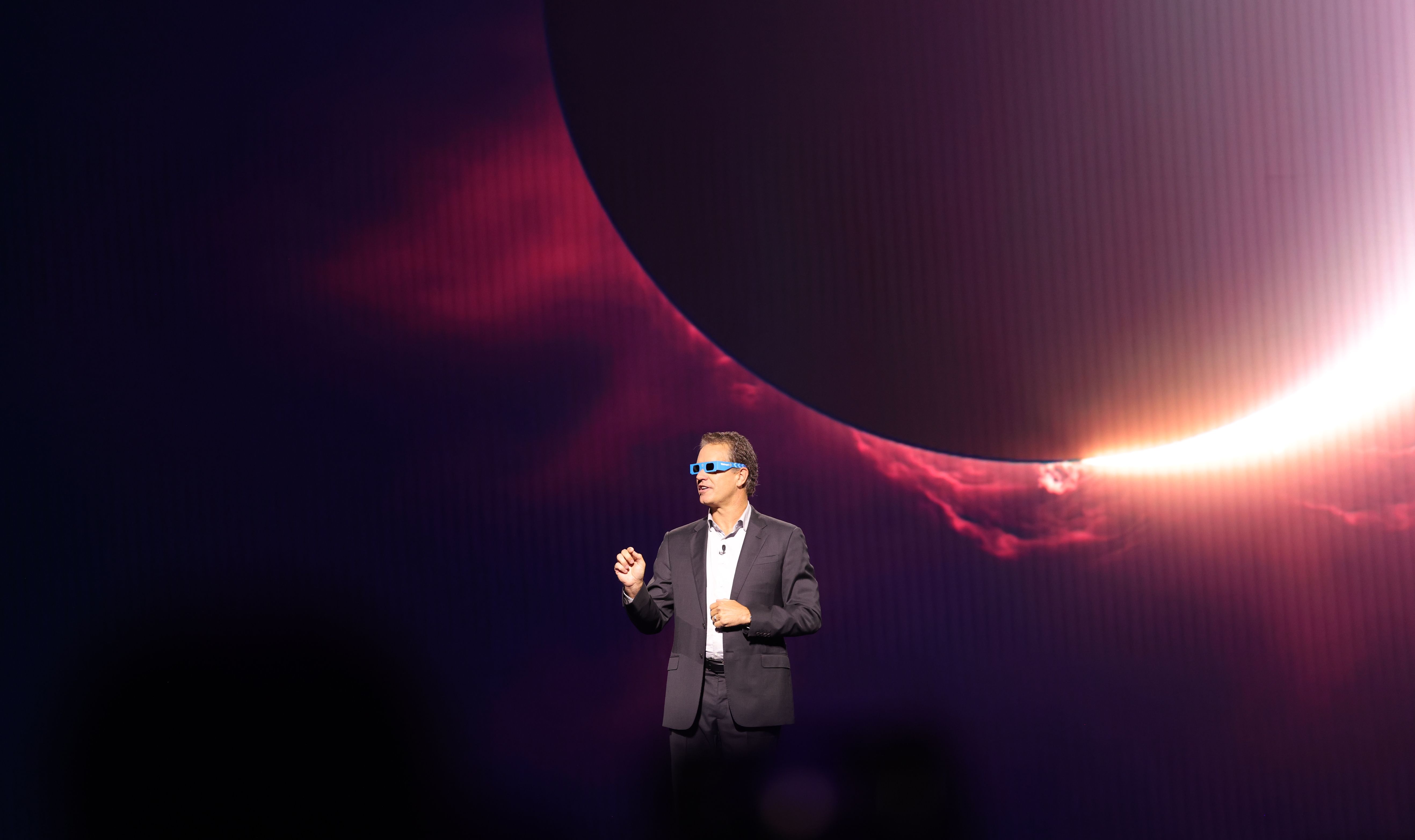 A man wears eclipse glasses.