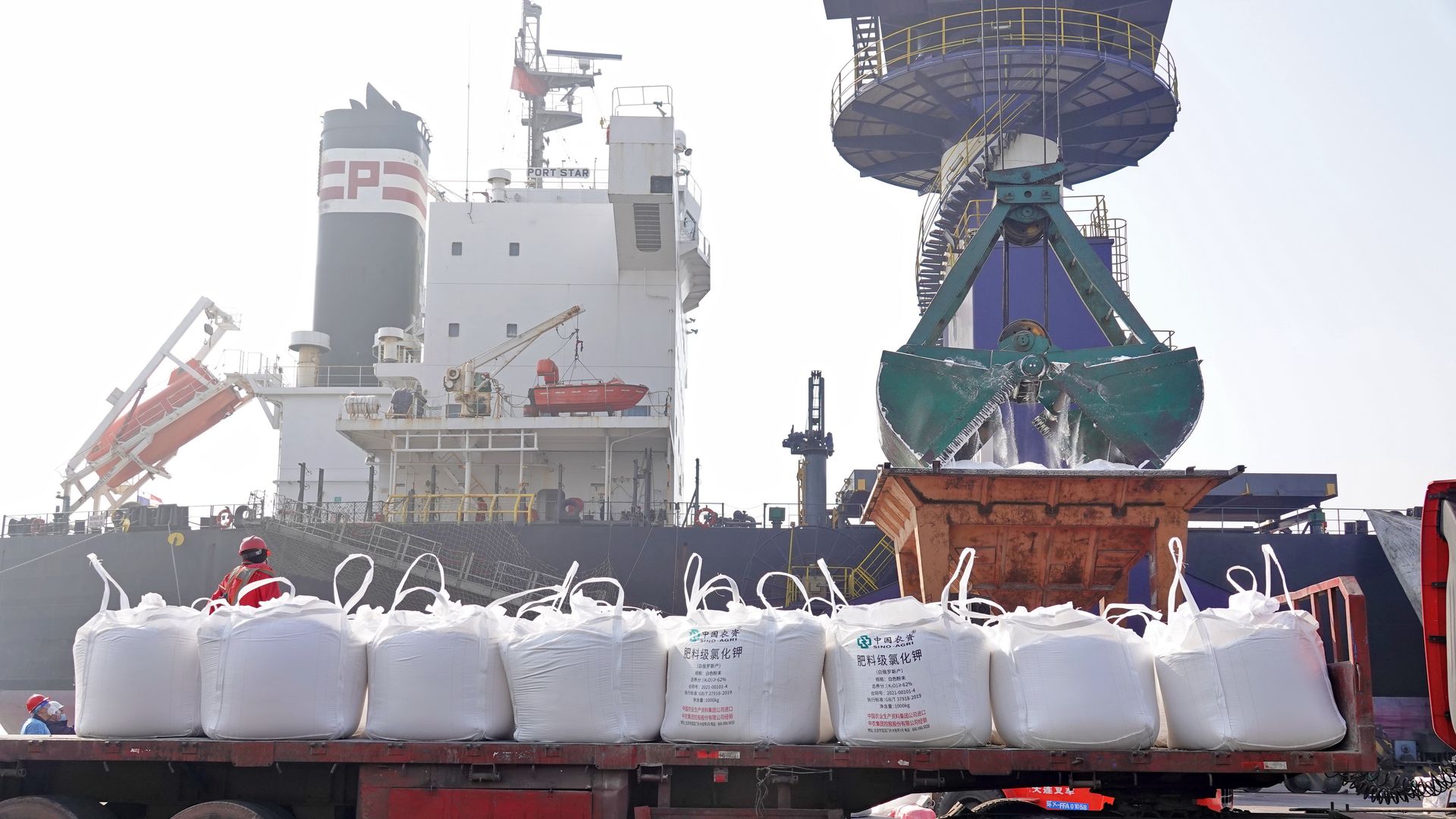 White bags of fertilizer sit on a truck at a factory