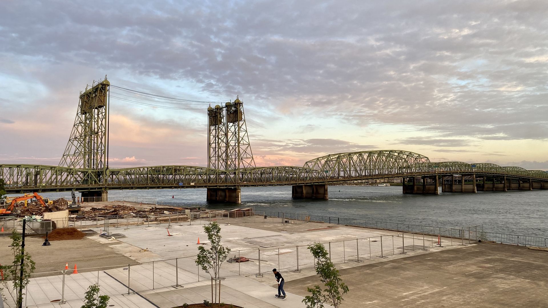 A view of the Interstate 5 bridge over the Columbia River with the sunset in the background.