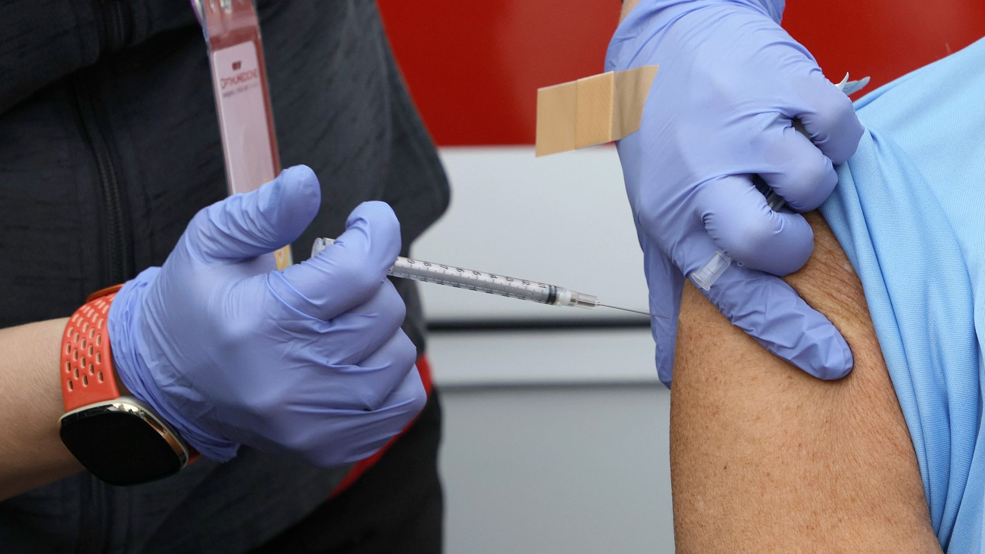 Picture the hands of a health care professional vaccinating someone's arm