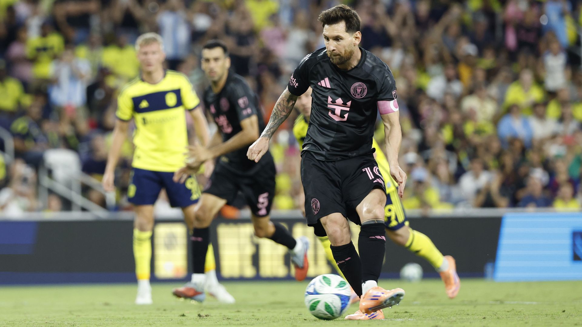 Lionel Messi kicking the soccer ball. 