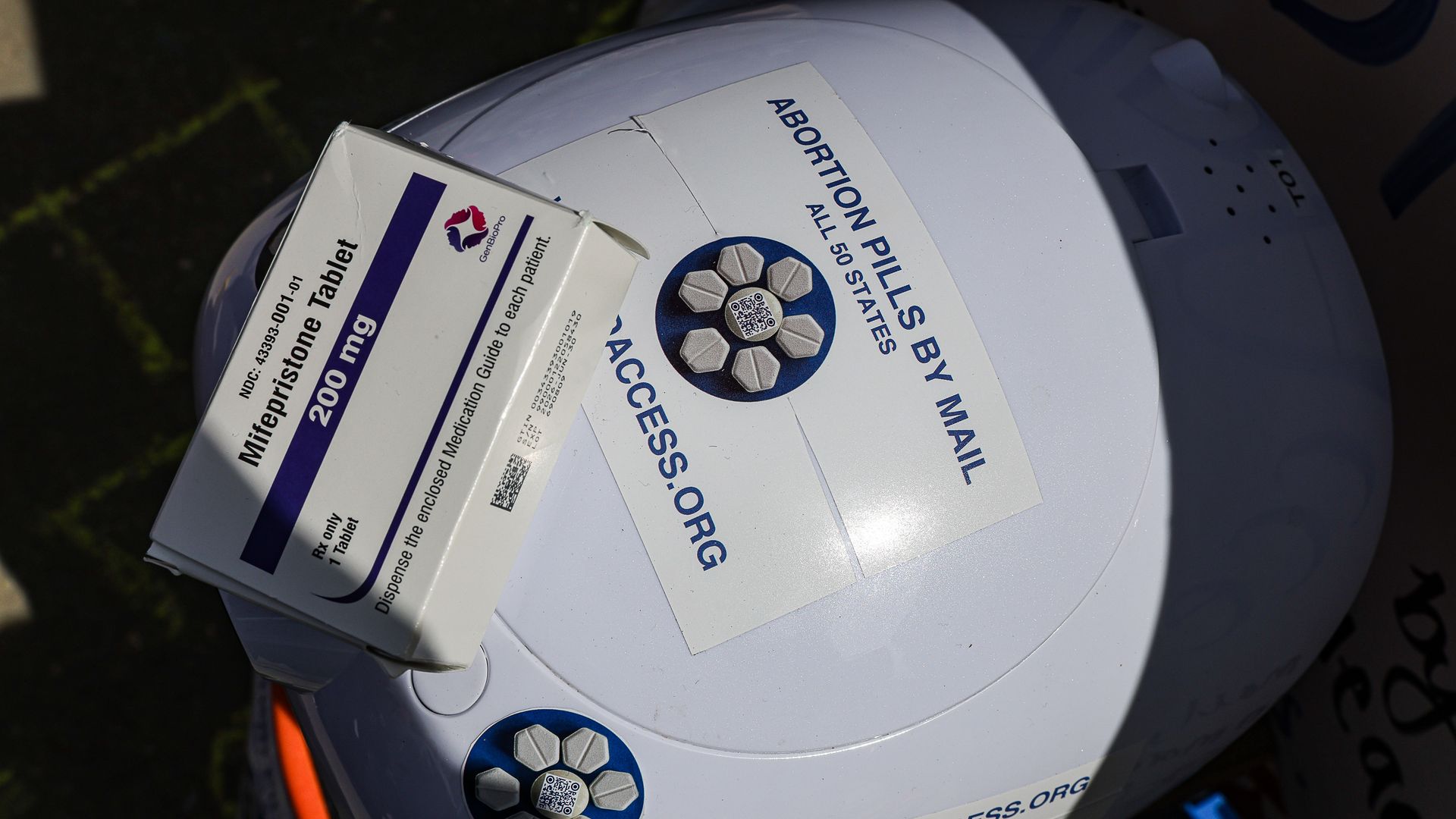 A box of Mifepristone pills is on top of a "robot" 