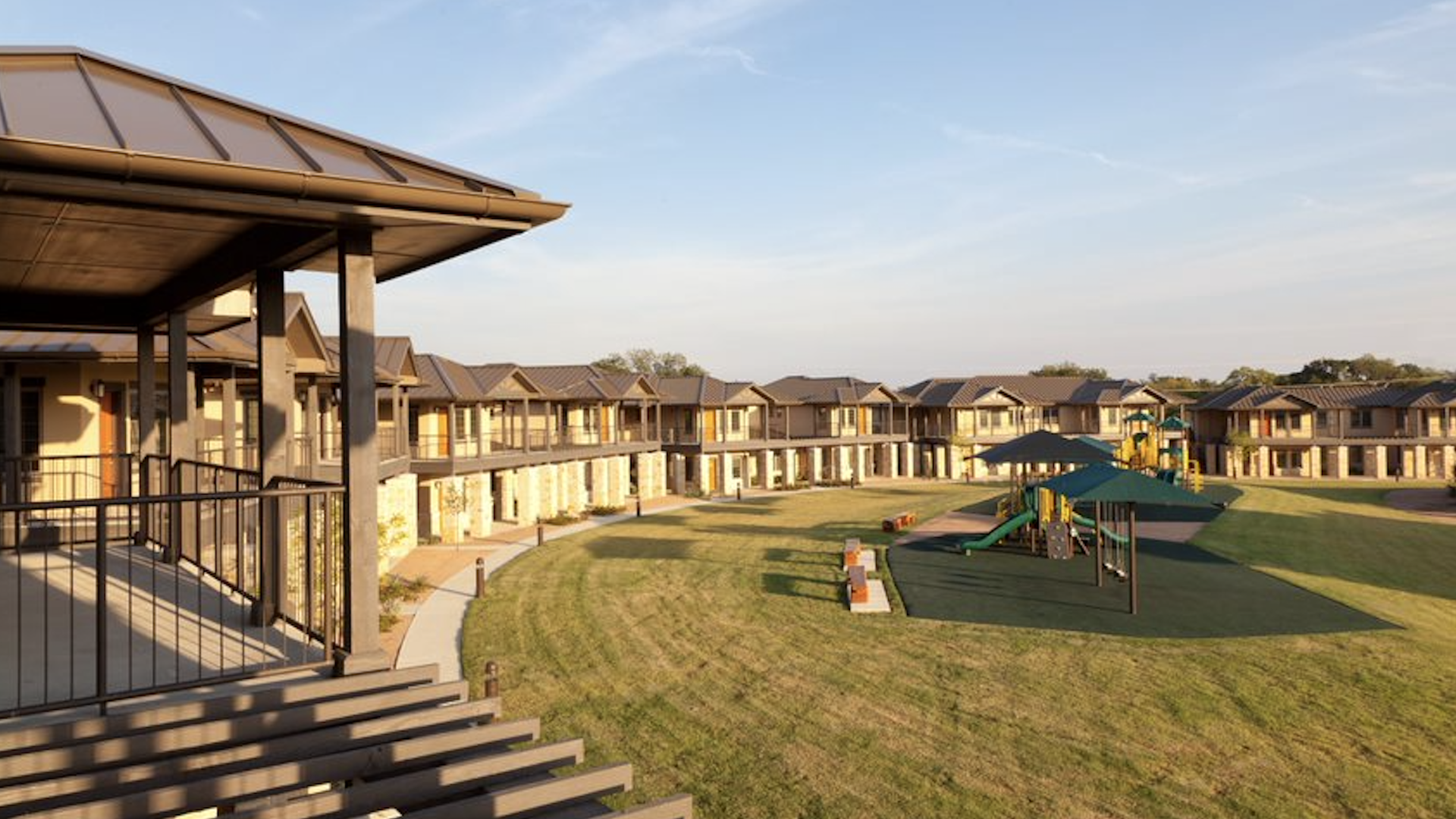 Apartments laid out in a horseshoe with a playground in the middle