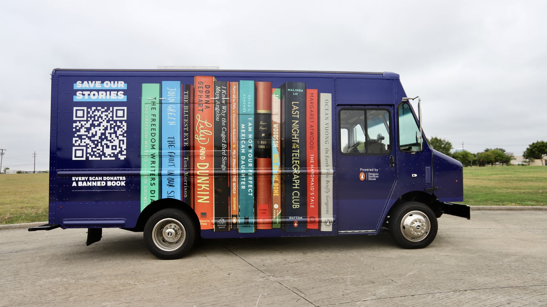 A photo in profile of a van with spines of banned books painted on its side