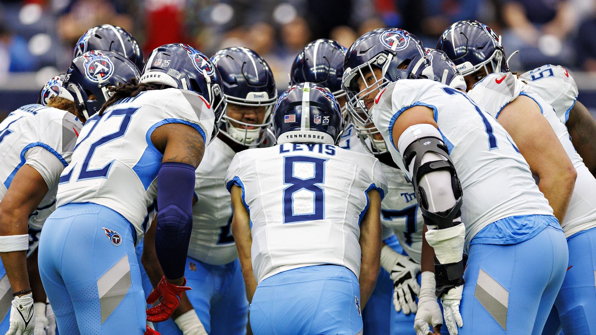 Titans players huddle during a game.