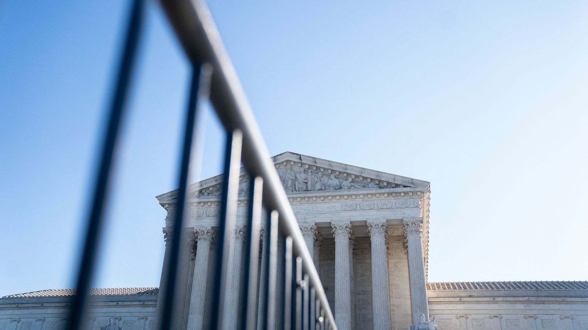 Photo of the Supreme Court and a guardrail in front