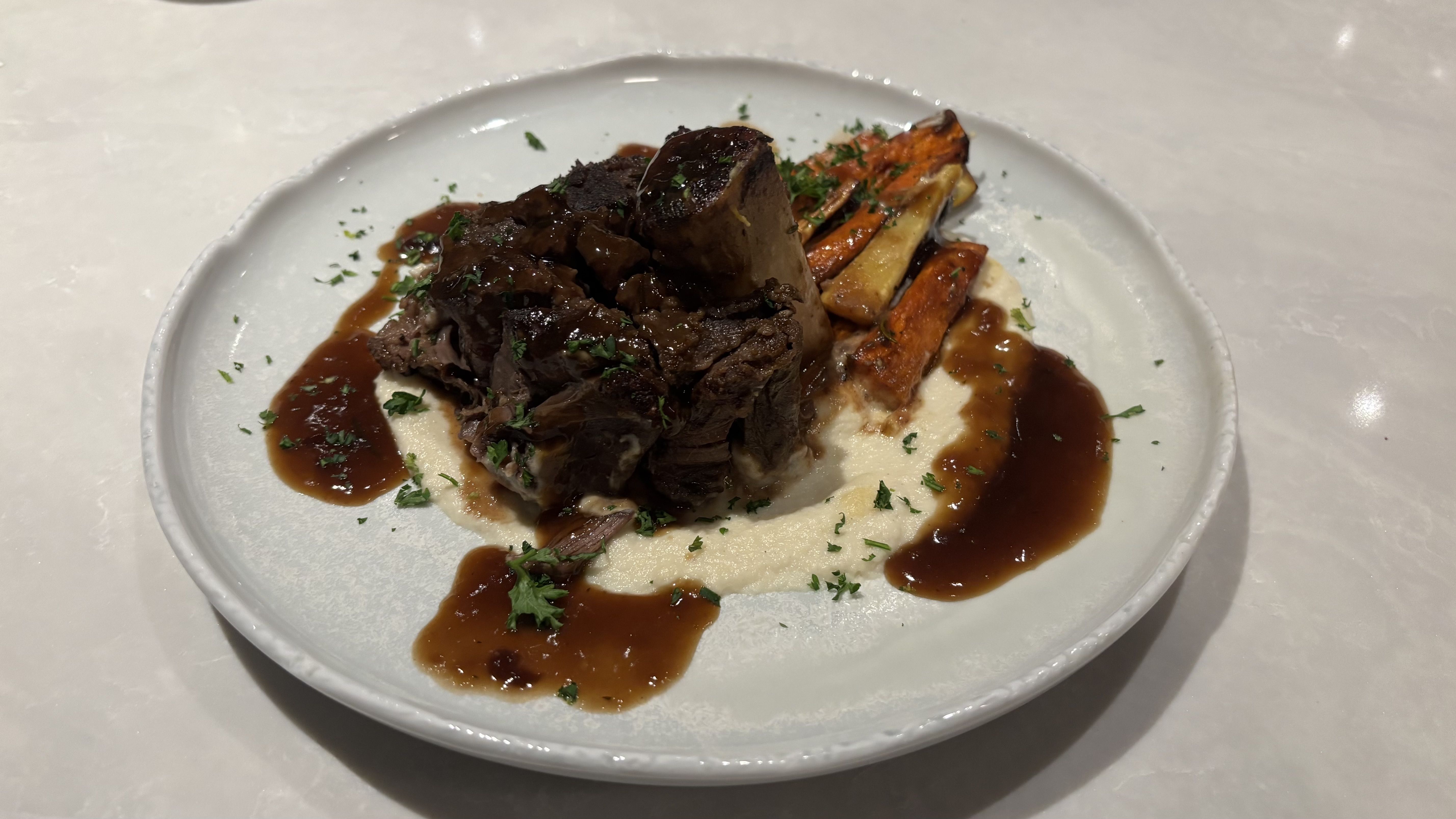 An elk dish with root veggies.