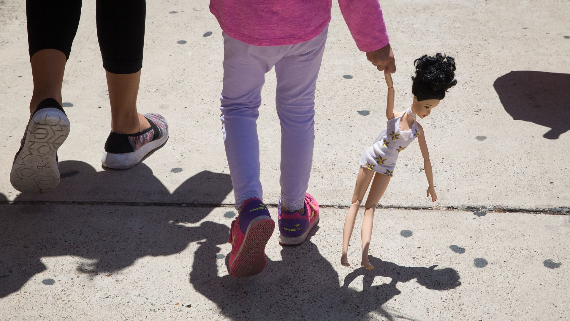 An immigrant mother walking with her child