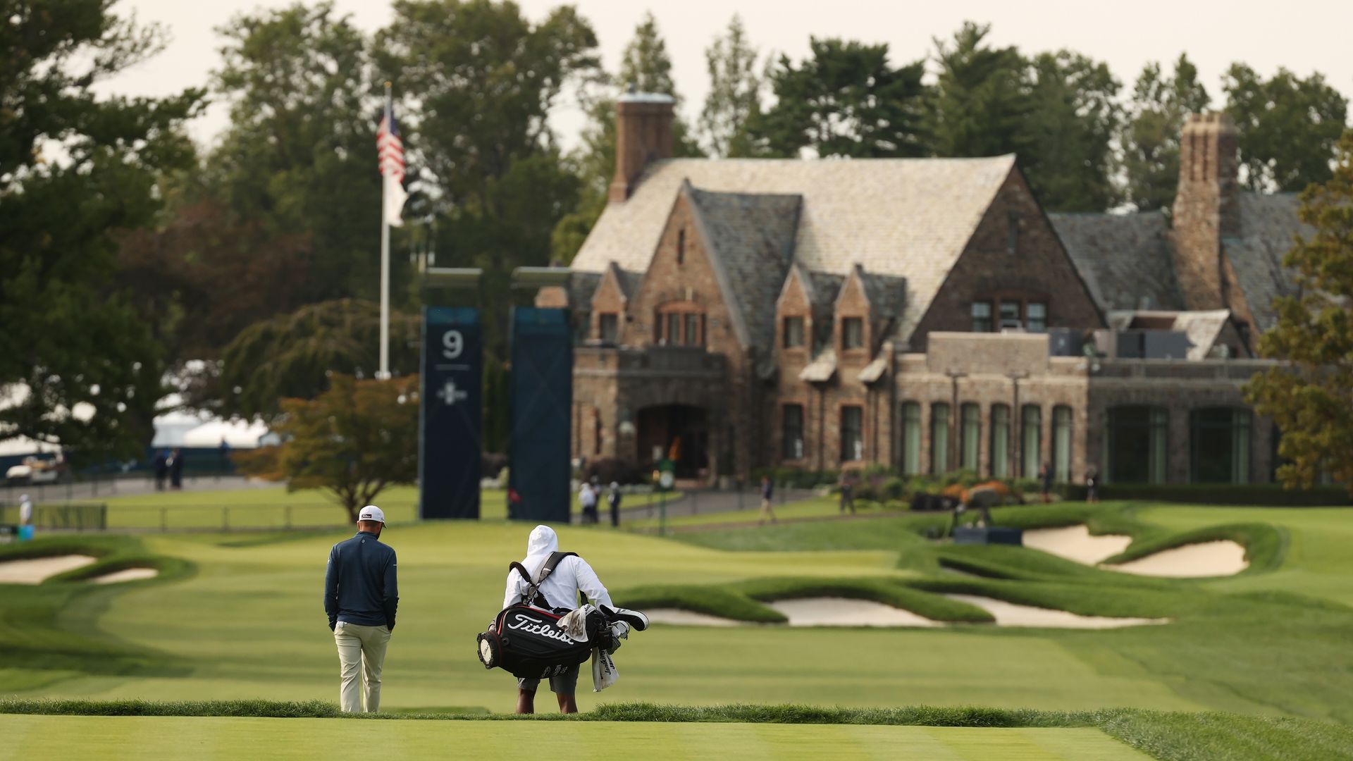 Golfer walks towards green