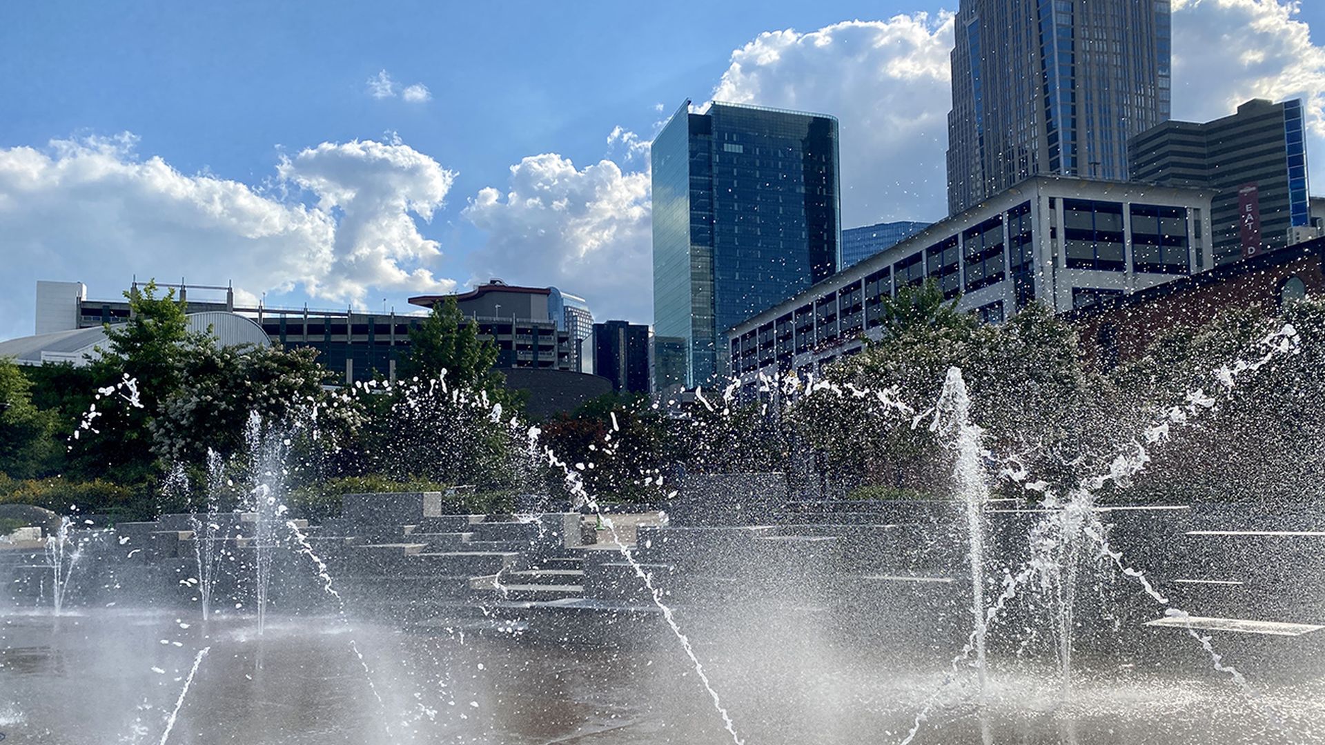 spray ground with water flying and the Charlotte skyline in the backdrop