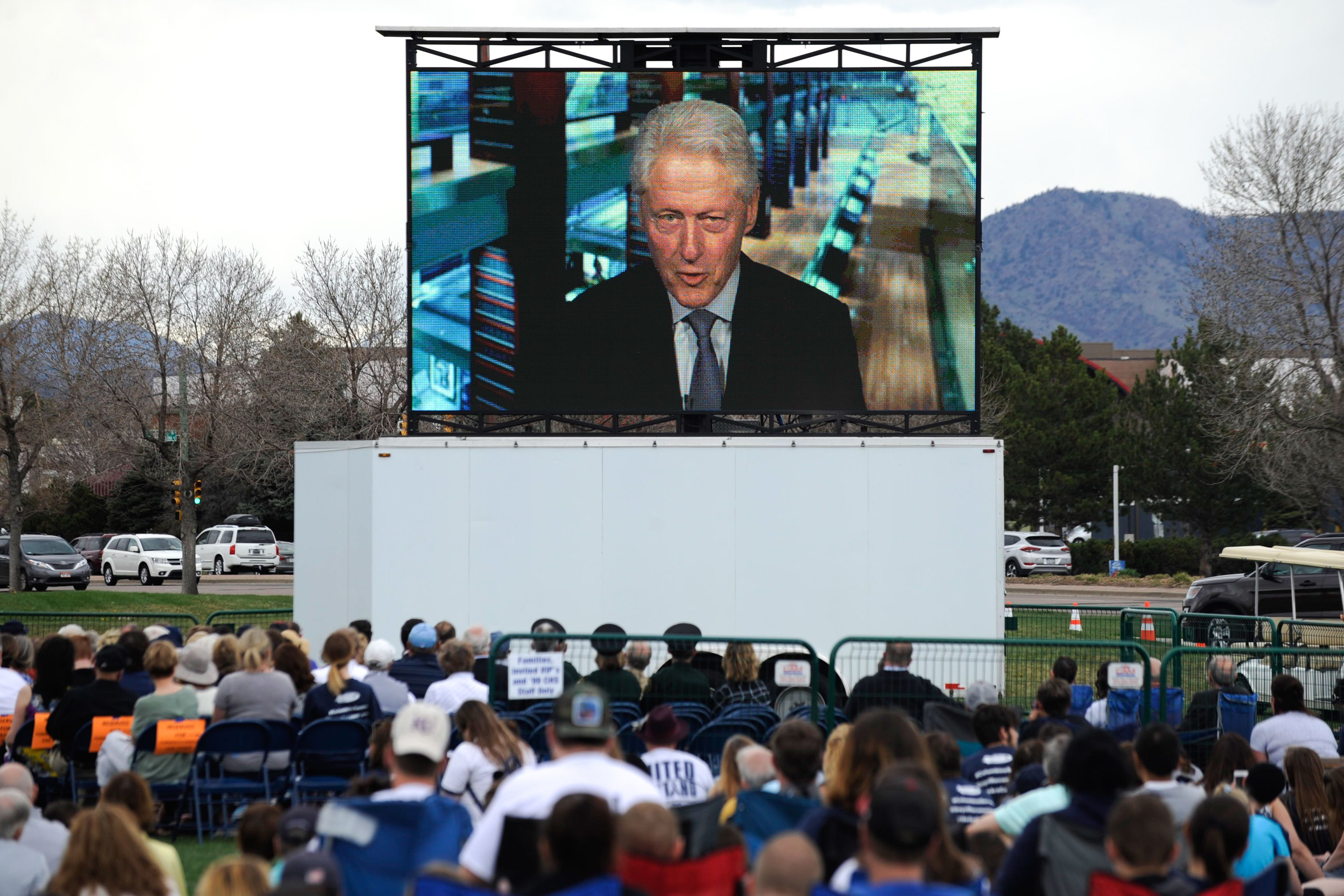 A video message from President Bill Clinton  is played on a screen during the Columbine Remembrance Ceremony.