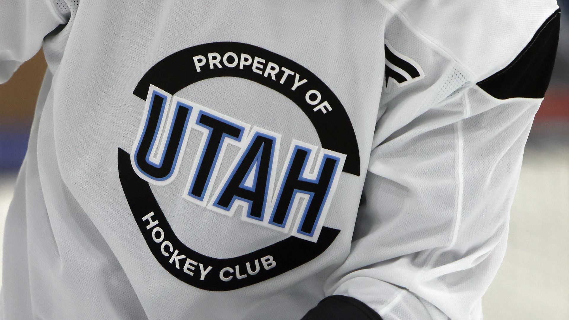 A hockey shirt reads "Property of UTAH Hockey Club"