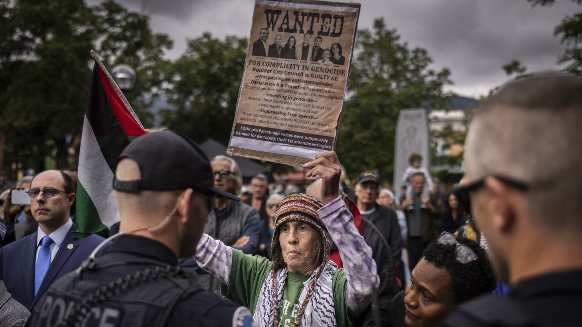 A protester holds a sign supporting Palestinians and targeting Boulder council members at a rally in Boulder on Wednesday. 