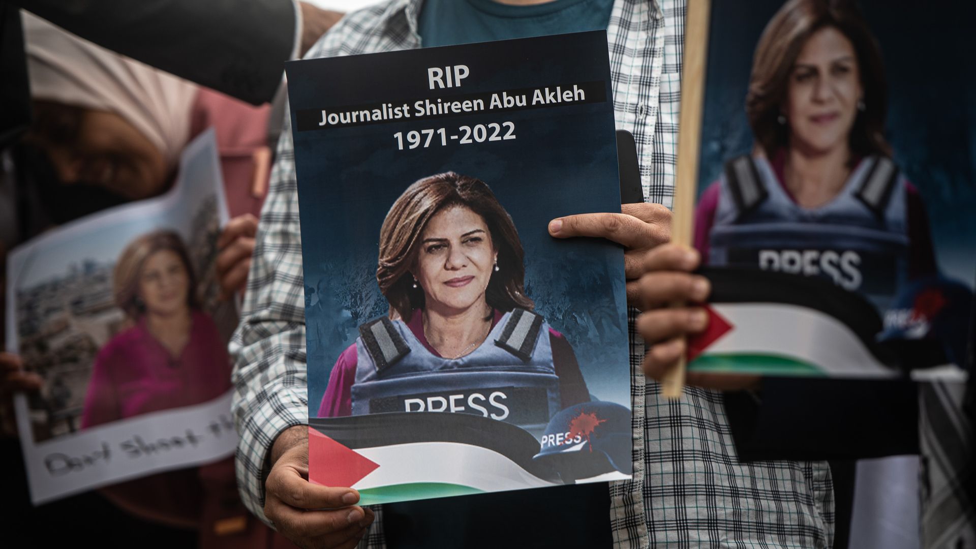 A person holds a sign with the picture of Shireen Abu Akleh at a protest in London on May 12. Photo: Guy Smallman/Getty Images