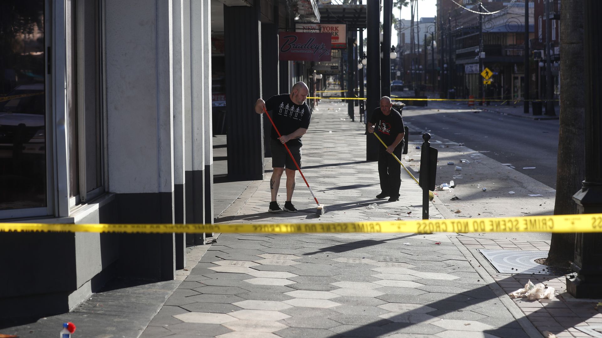 People clean up after a fatal shooting in the Ybor City neighborhood on October 29, 2023 in Tampa, Florida. 