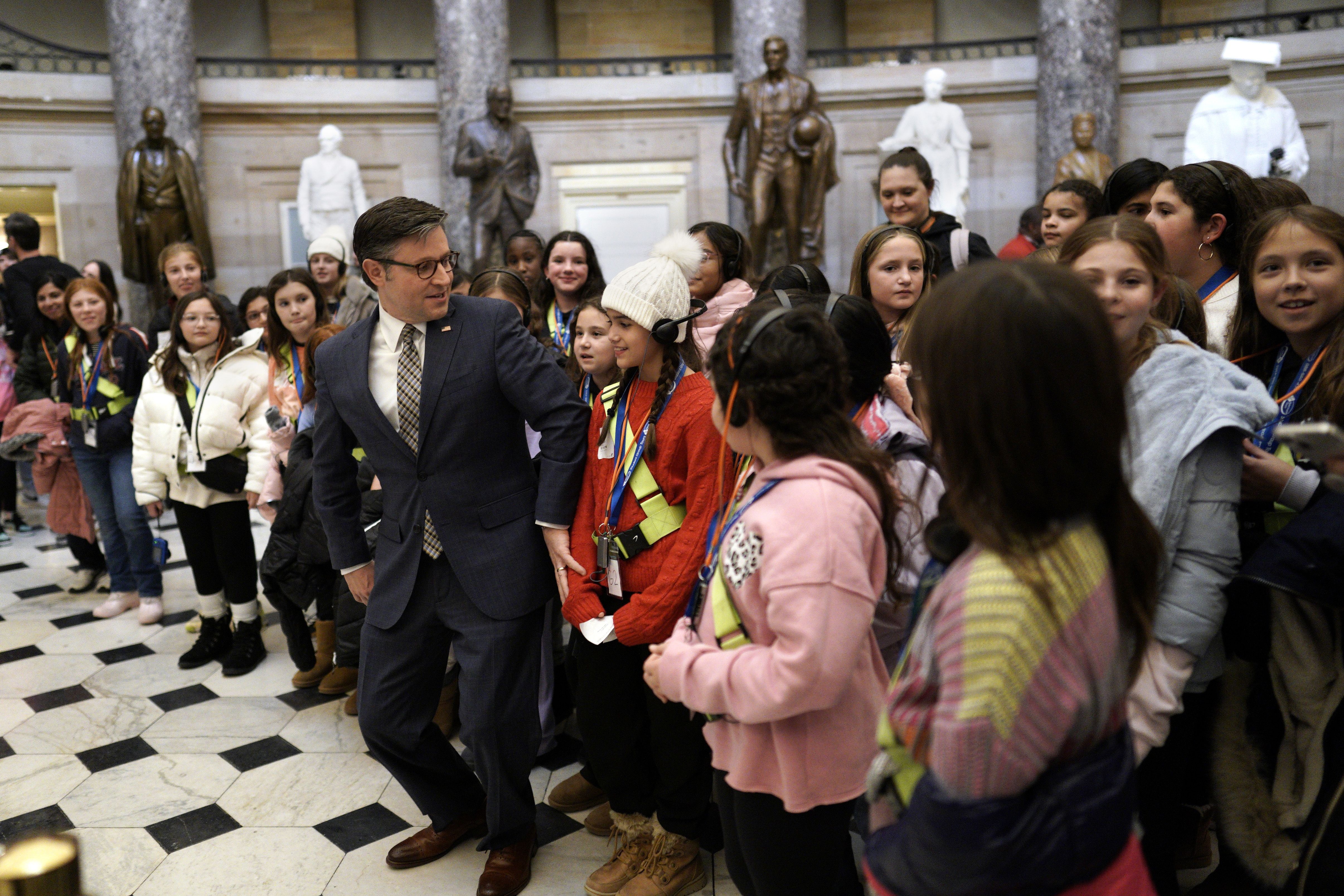Speaker Mike Johnson poses with kids at the U.S. Capitol