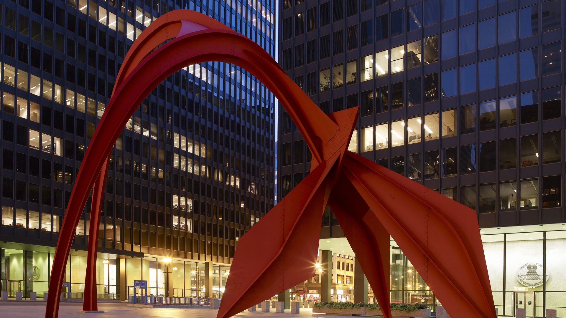 Photo of a sculpture in front of buildings in an office plaza 