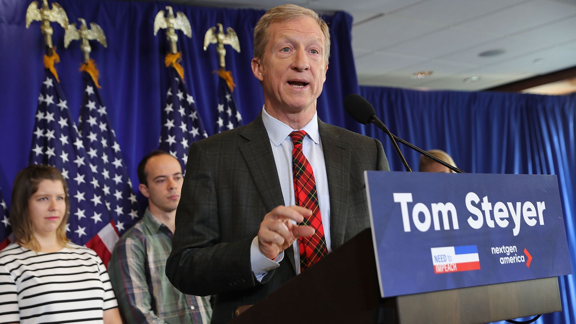 Tom Steyer standing at a podium. 
