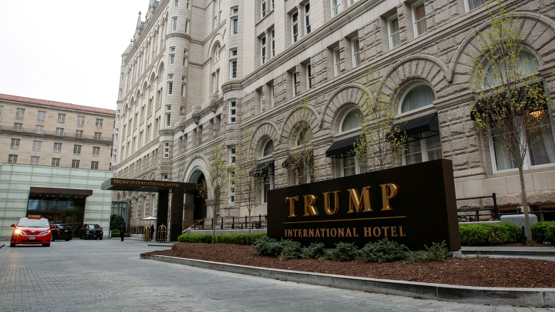 In this image the Trump International Hotel sign is seen in front of a hotel building. 