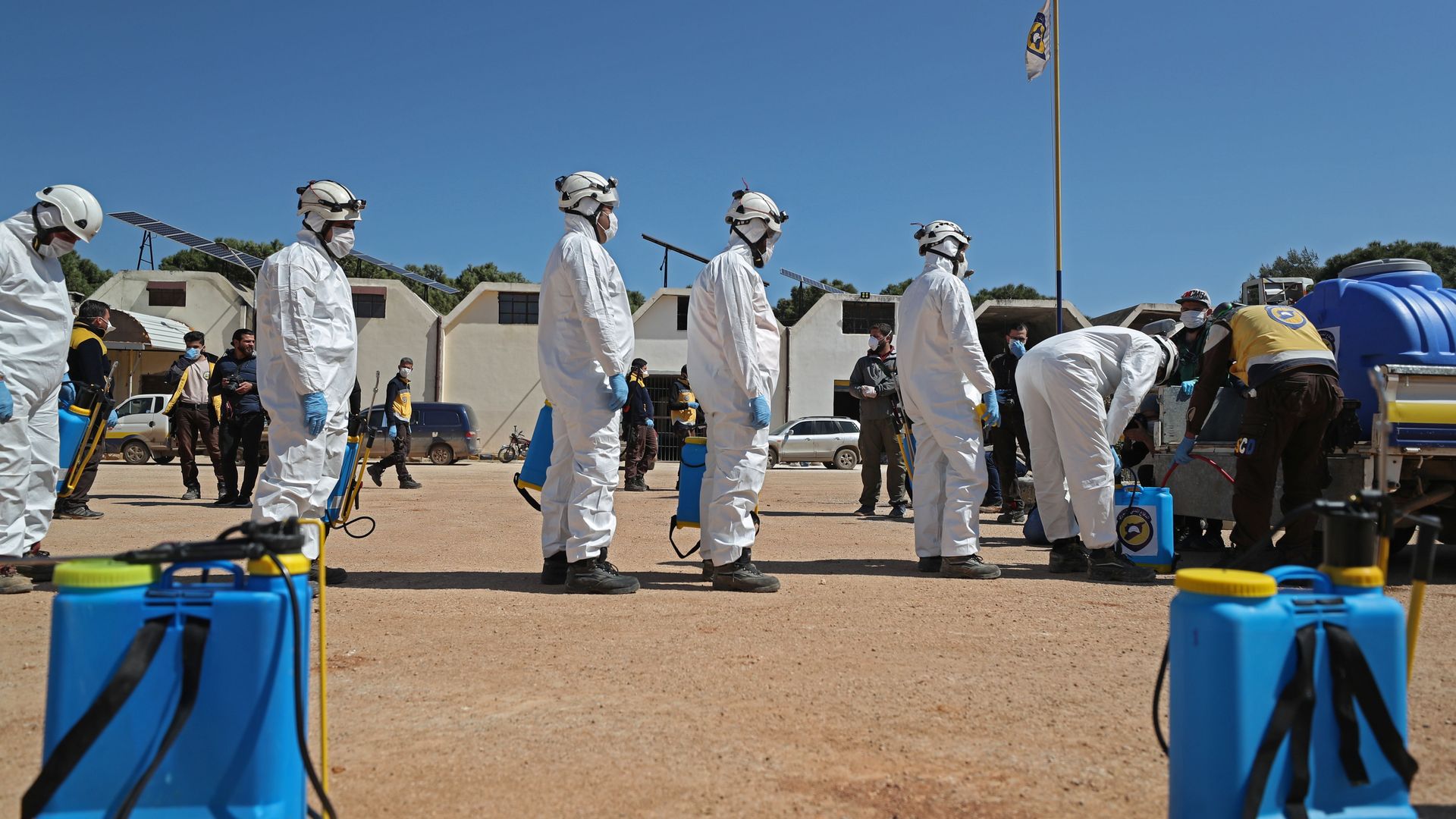 Members of the Syrian Civil Defence, also known as the "White Helmets", prepare their sterilisation equipment before sterilising a hospital in Syria's northwestern Idlib city.