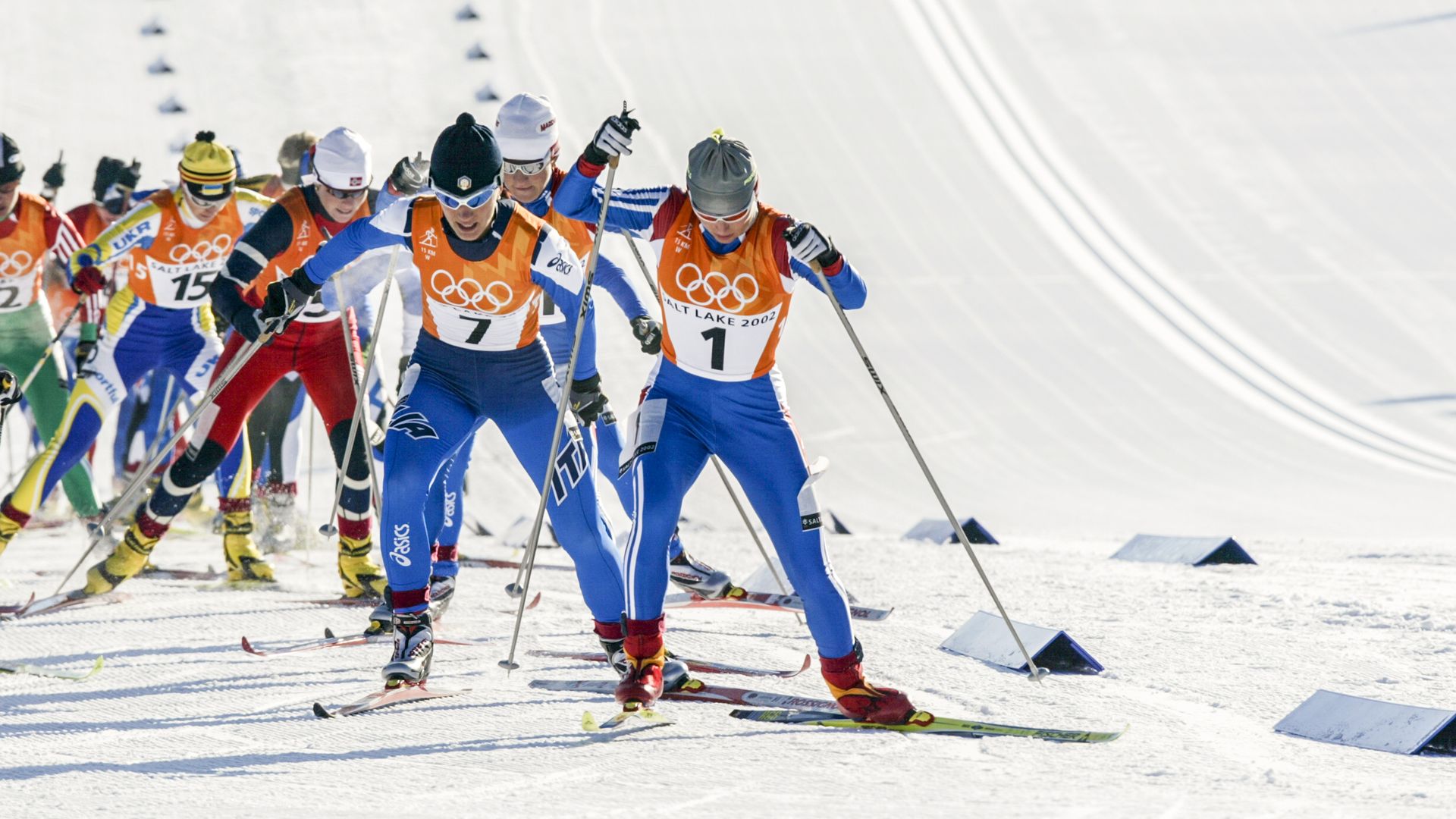 Cross country skiers compete at the Olympics.
