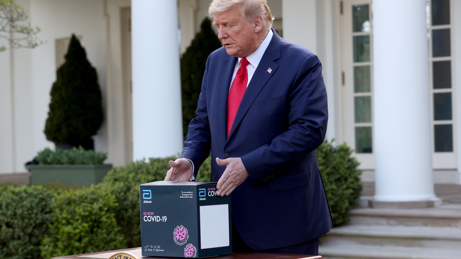 In this image, Trump holds the coronavirus test at the White House