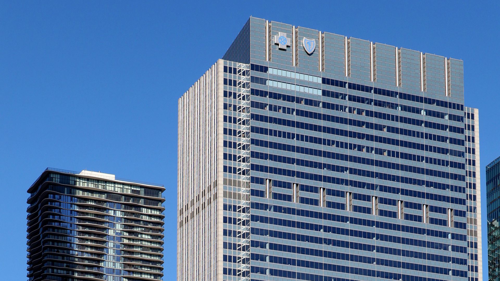 Two tall buildings with the Blue Cross Blue Shield logo on the one in the foreground.
