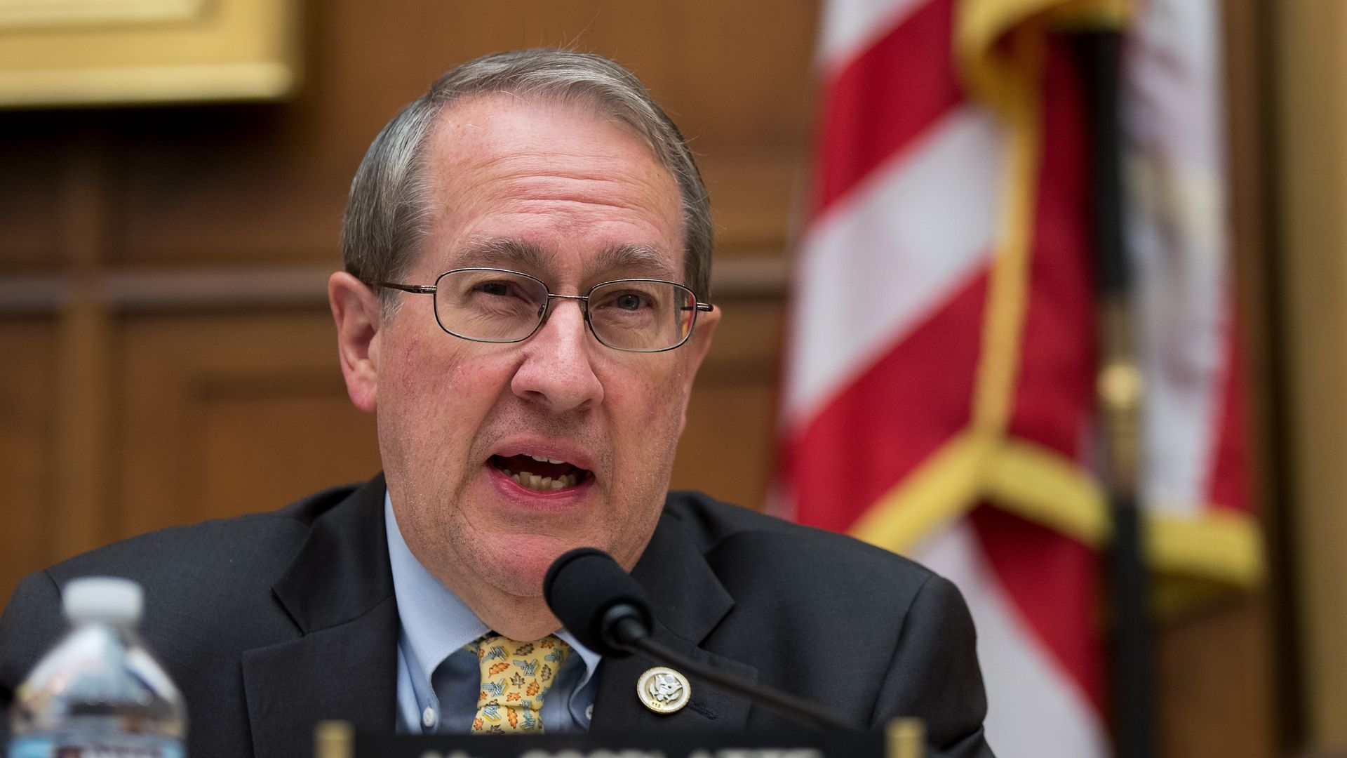Judiciary Committee Chairman Rep. Bob Goodlate speaking with a flag behind him