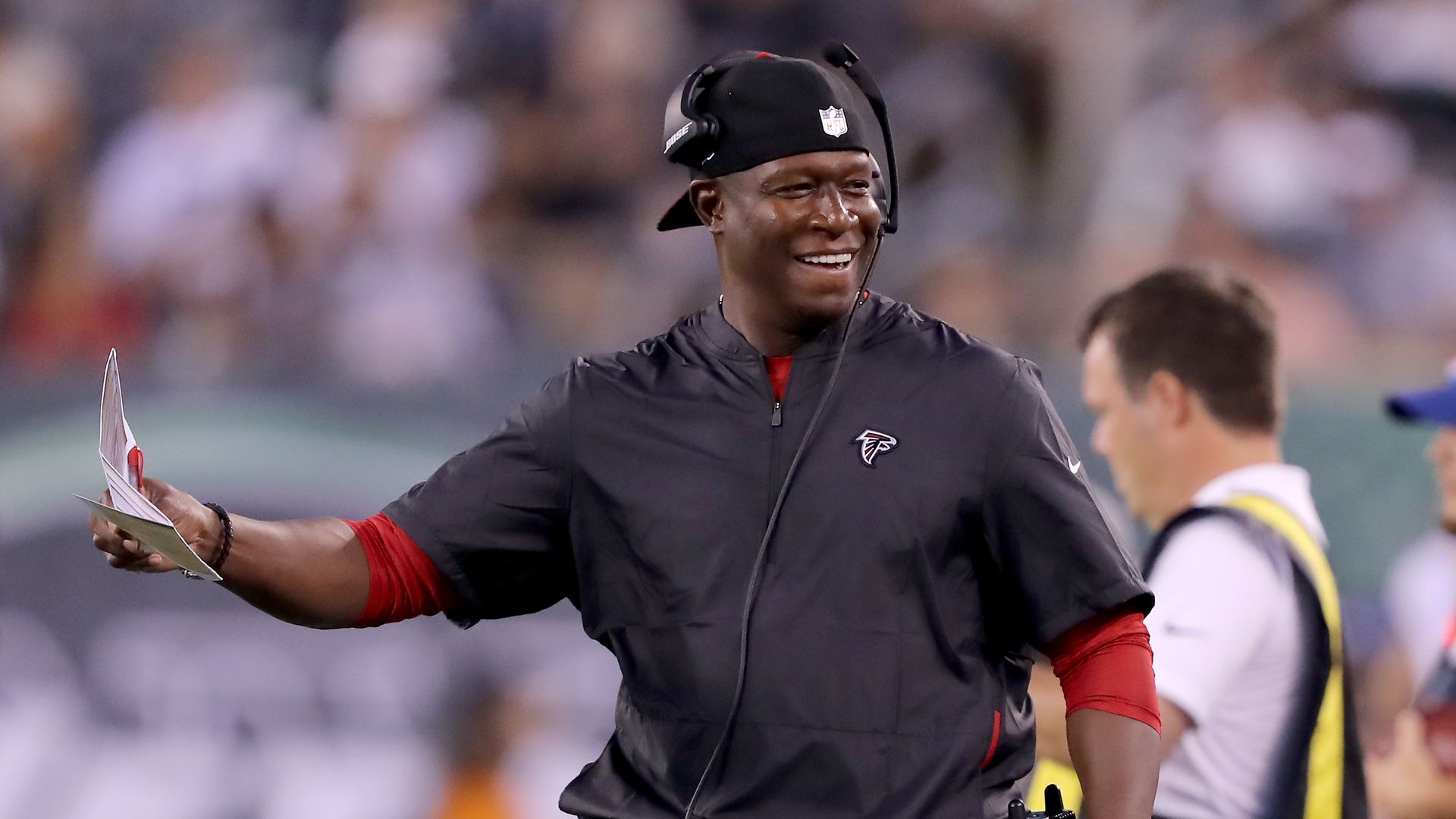 A black man coaching a football team 