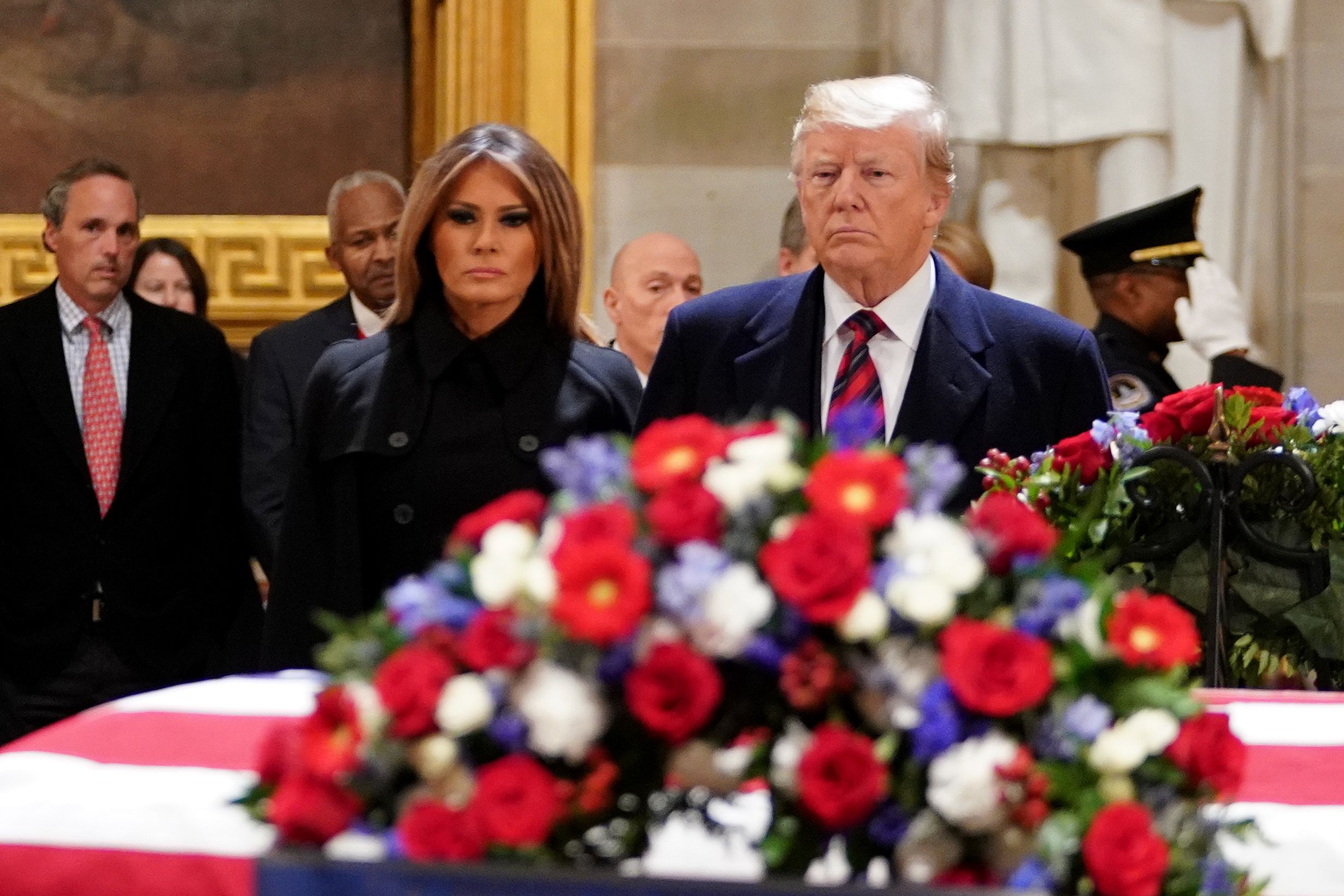  President Donald Trump and First Lady Melania Trump pay their respects as US president George H. W. Bush lies in state in the Rotunda of the US Capitol 
