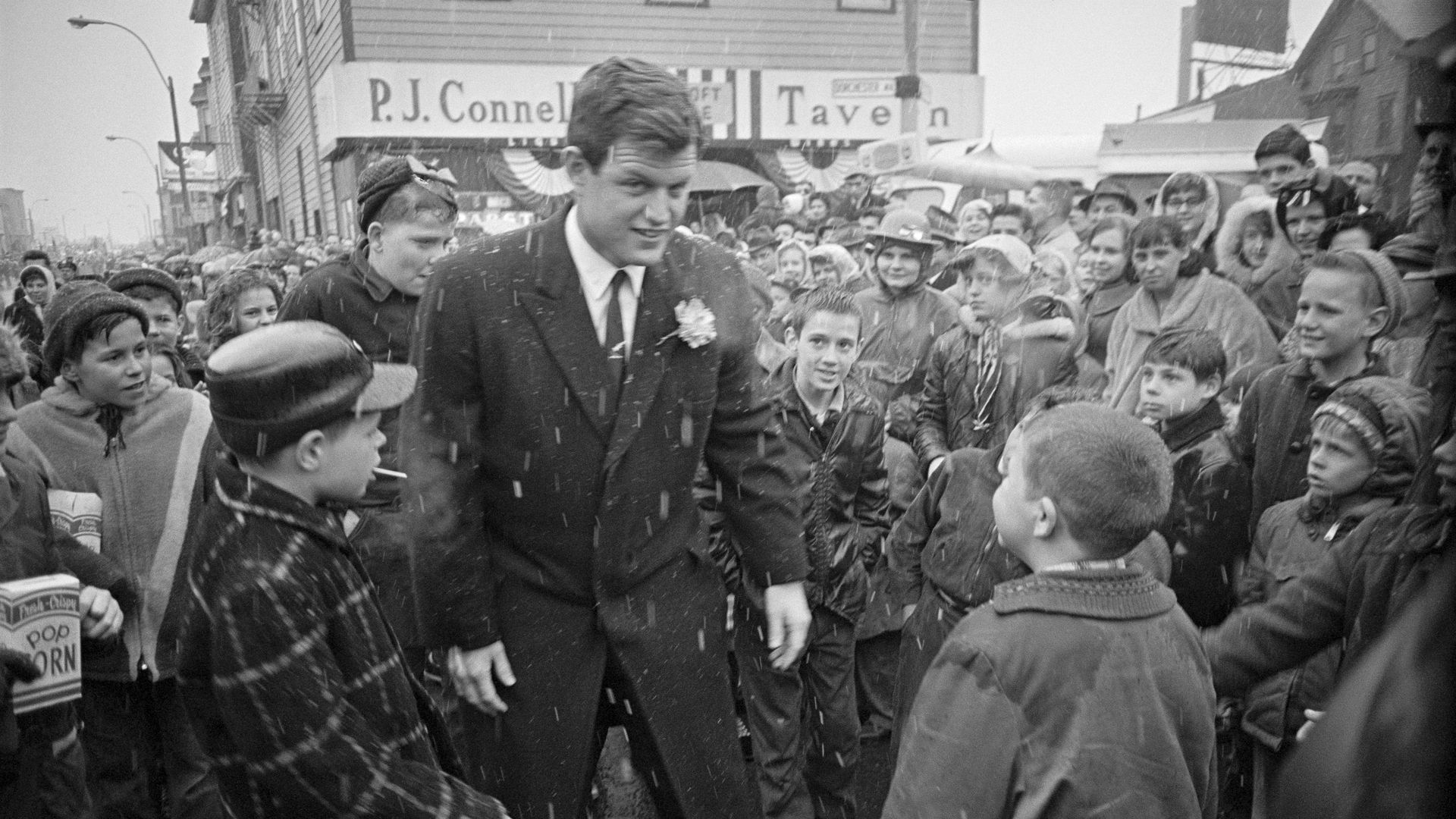 Sen. Edward Kennedy broke away from the snowy 1964 parade to greet children along the route.